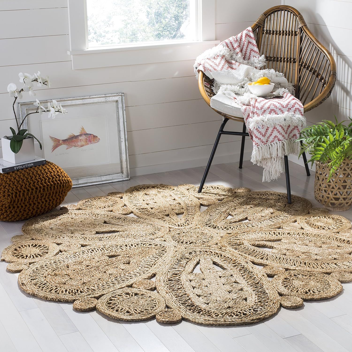 A beige floral-patterned crochet rug in a natural, organic shape adds bohemian style to a light wood floor.