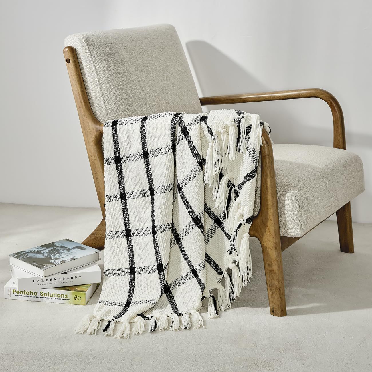 A sequence showing a striped blanket being rolled up from different angles on a white background.