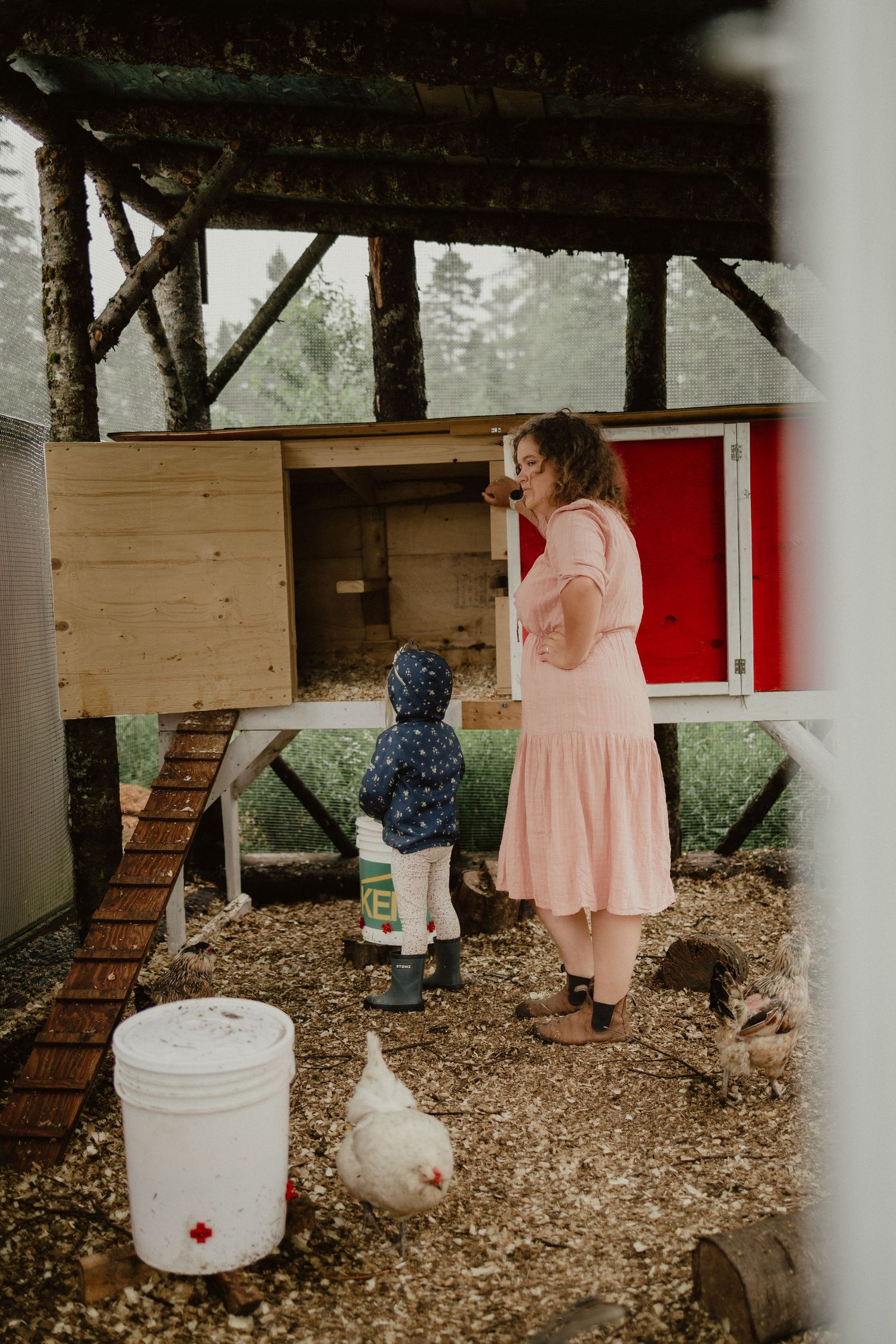 mom and daughter in chicken coop in nova scotia