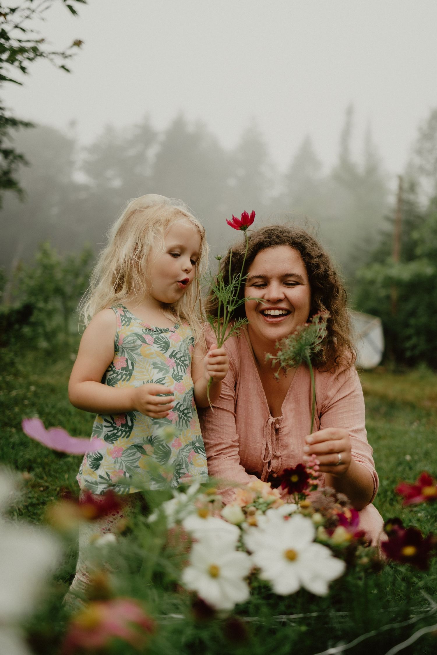 mom and daughter in flower garden