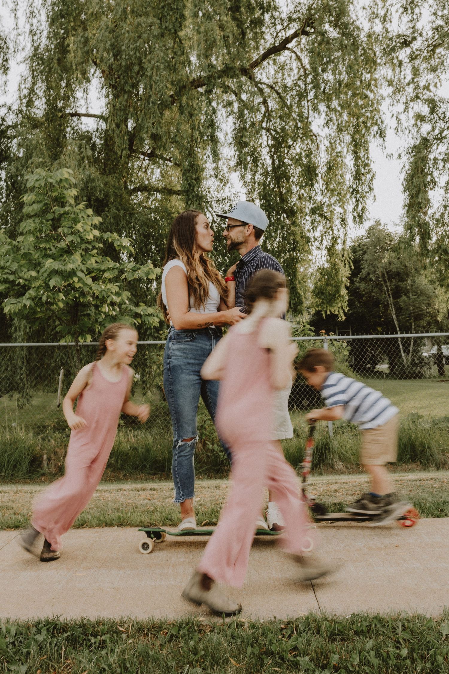 A family enjoying skateboarding together on the walking trail in Windsor Nova Scotia
