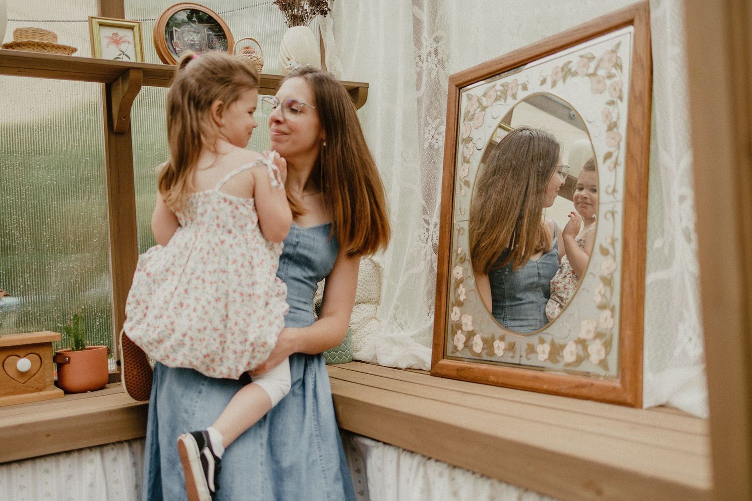 Family shares tender moments together in a warm and cozy home setting with framed artwork in the background.