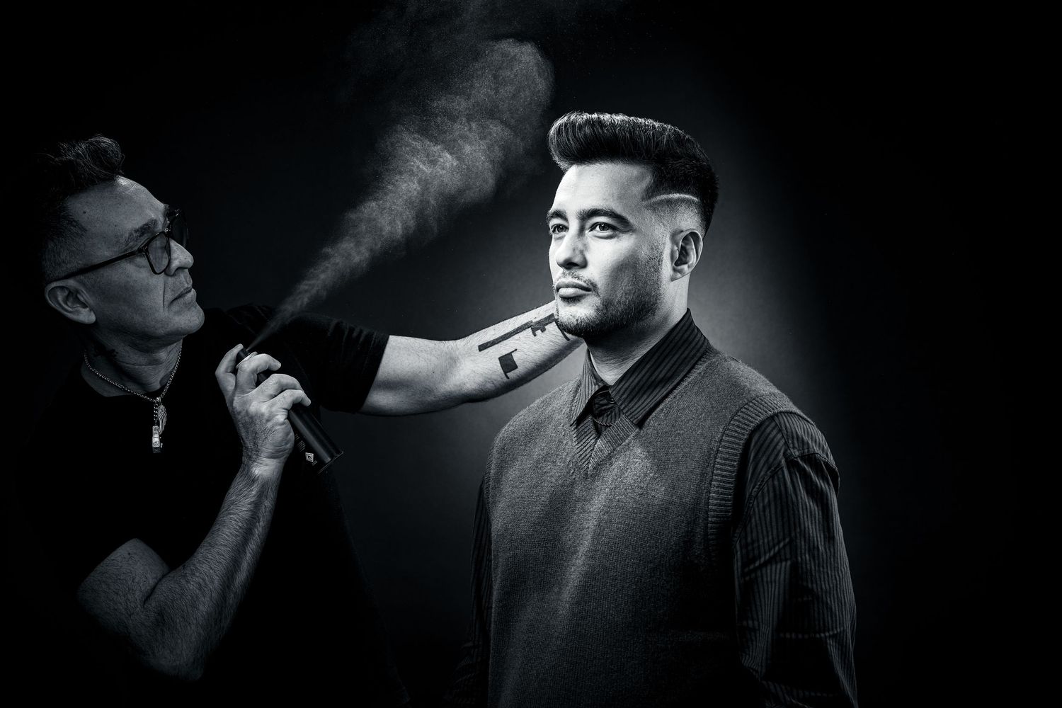 Black and white image of a barber, photographer Alec Watson