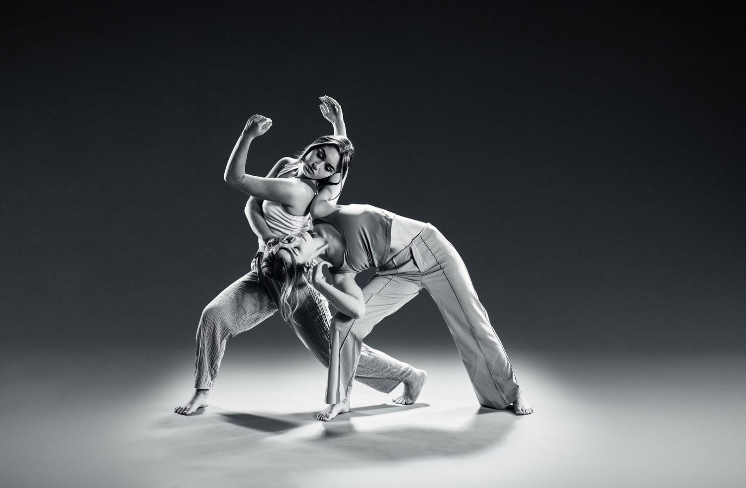 Artistic black and white photo of two dancers entwined in a dynamic pose, photographer Alec Watson