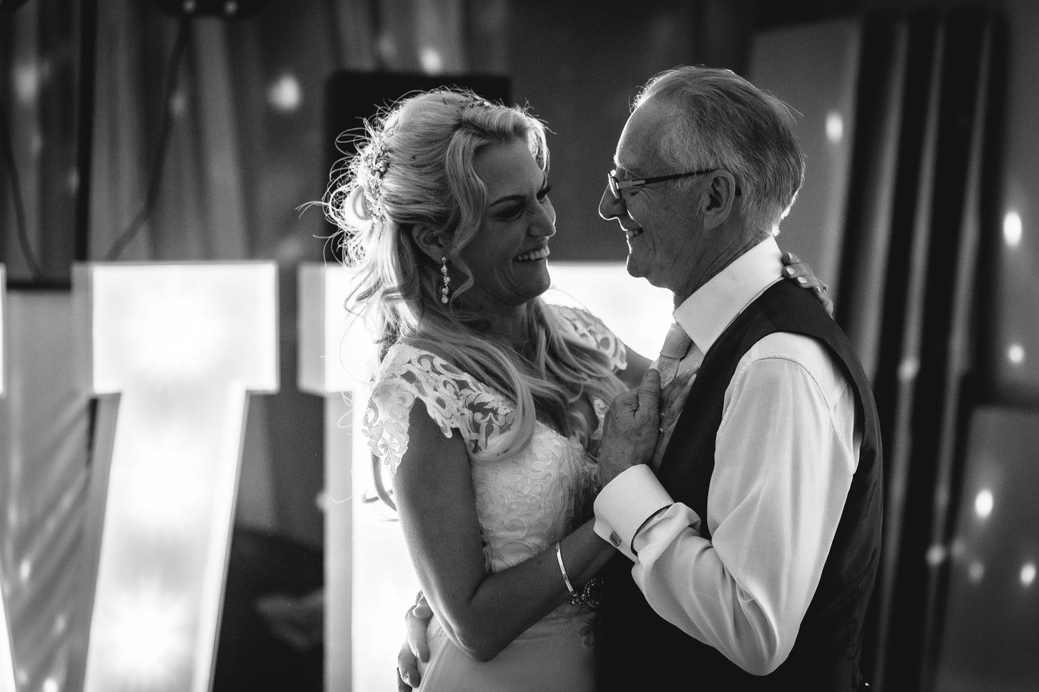 Black and white romantic dance moment captured during wedding reception.