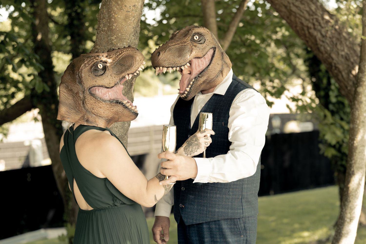 Couple sharing playful moments together in a sunlit park setting.