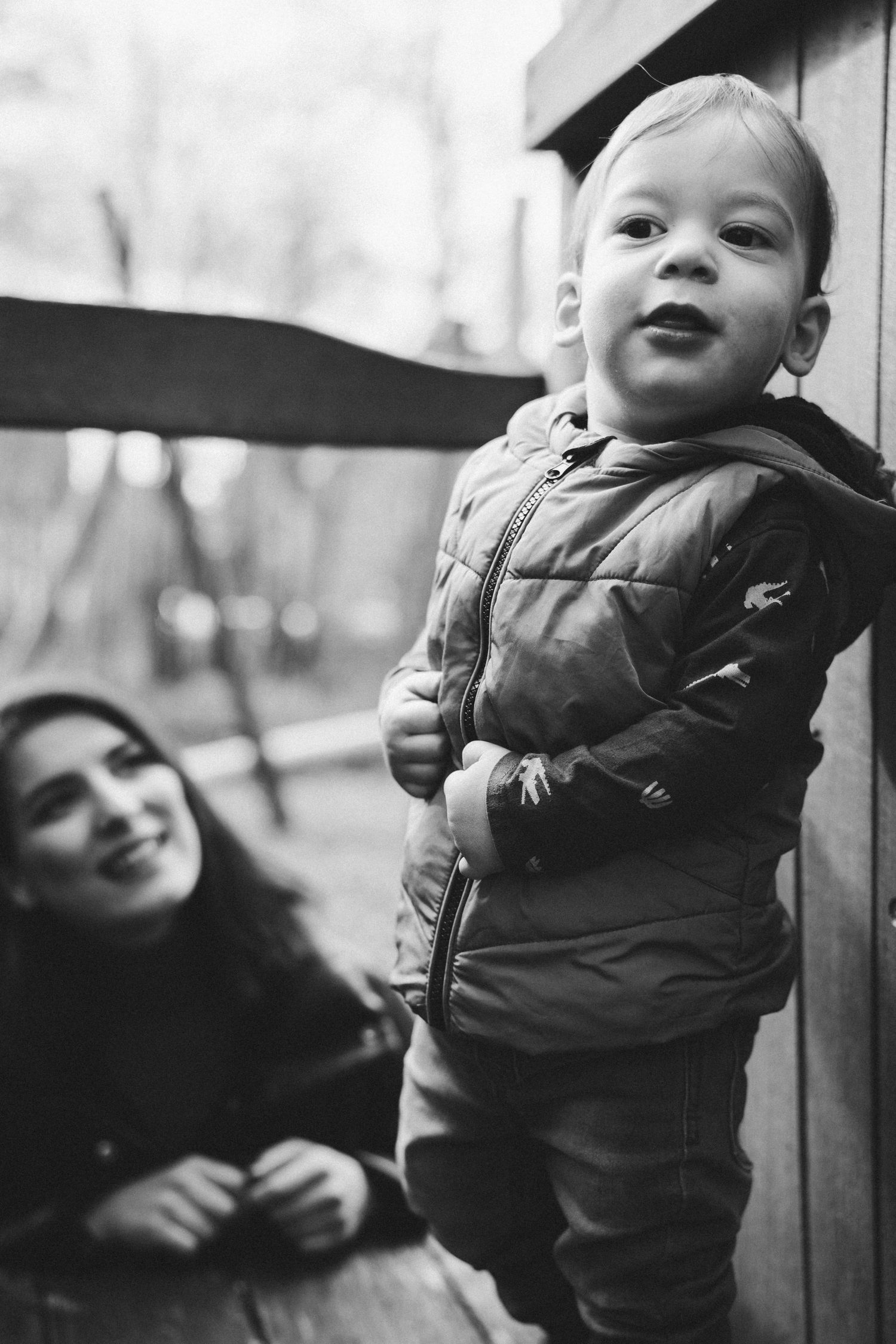 Black and white portrait of a small child in winter clothing.