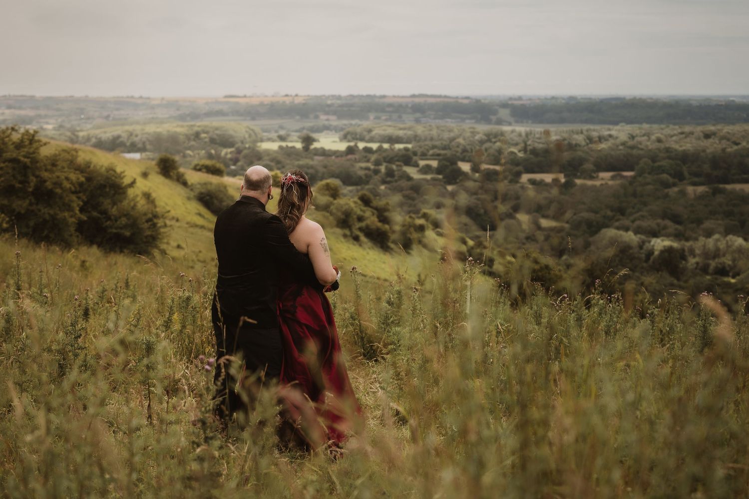 Scenic hilltop vista overlooking a vast rural landscape with scattered buildings and fields.