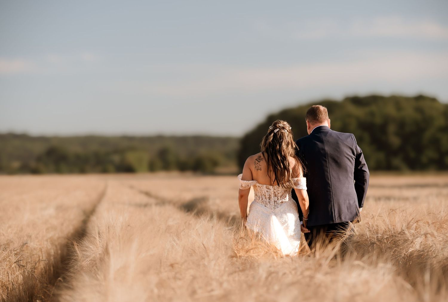 A romantic sunset moment captured in a golden wheat field.