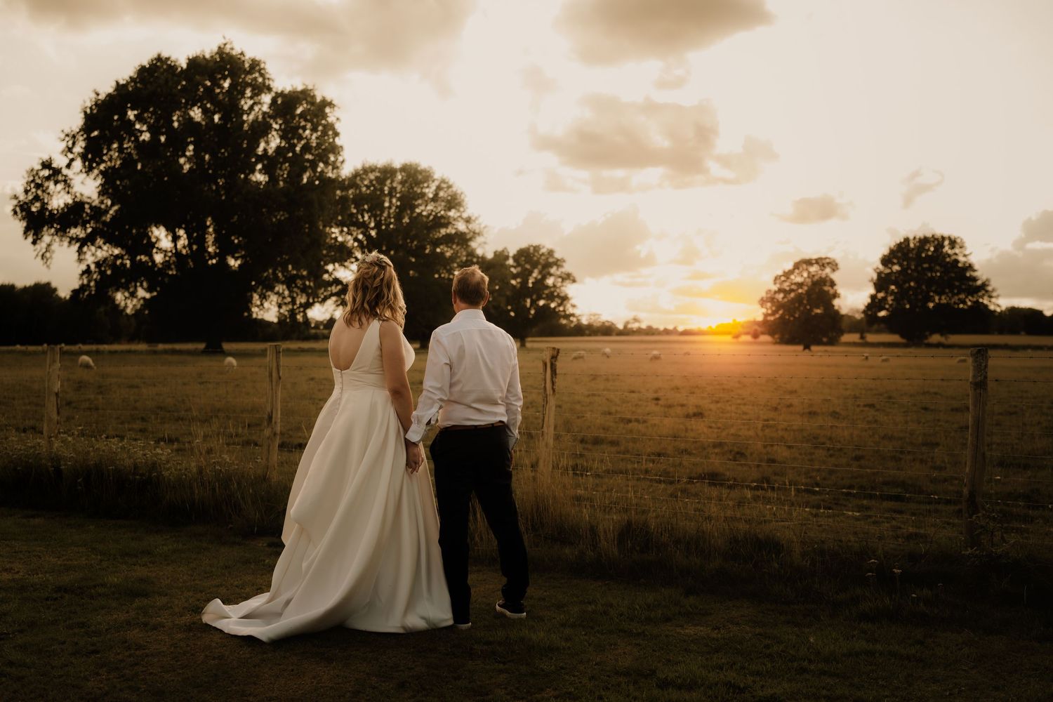 Sunset wedding portraits in a serene countryside setting.