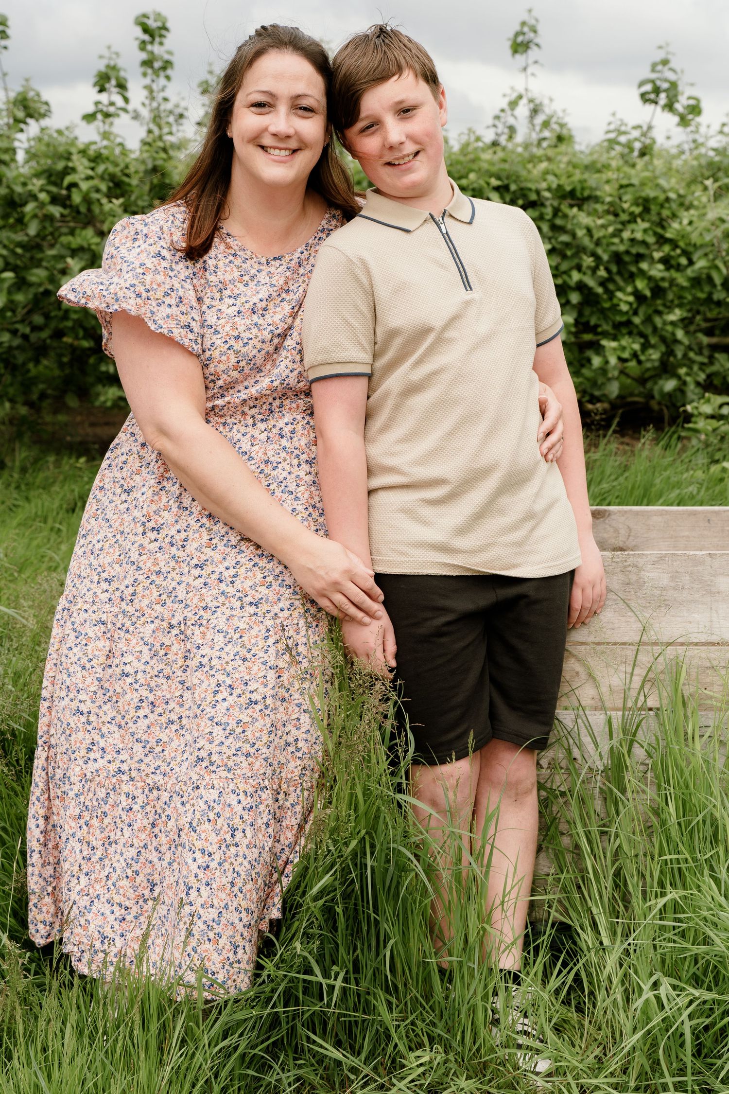 Sweet outdoor portrait session in tall grass with natural lighting.