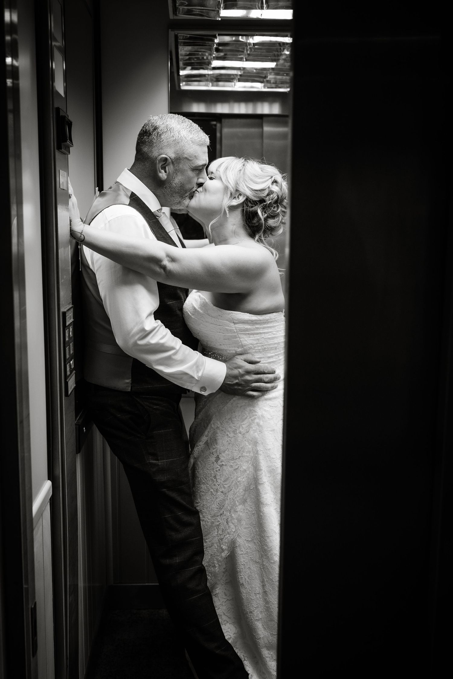 Intimate black and white dance moment captured in dramatic lighting and shadows.