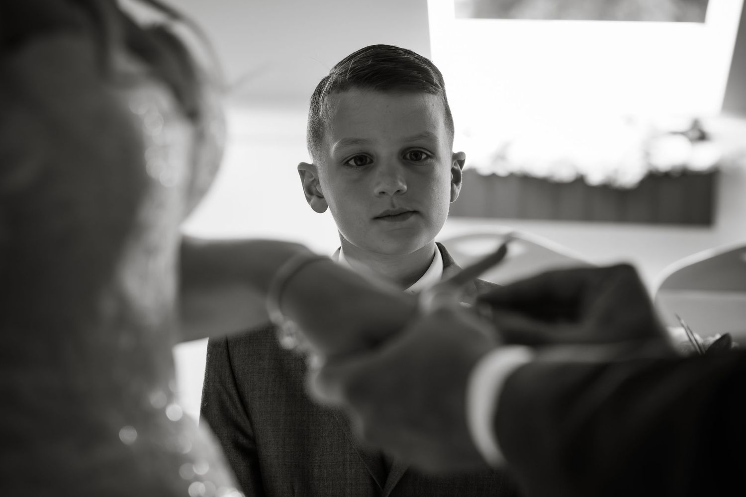 Black and white emotional moments captured during a wedding ceremony.