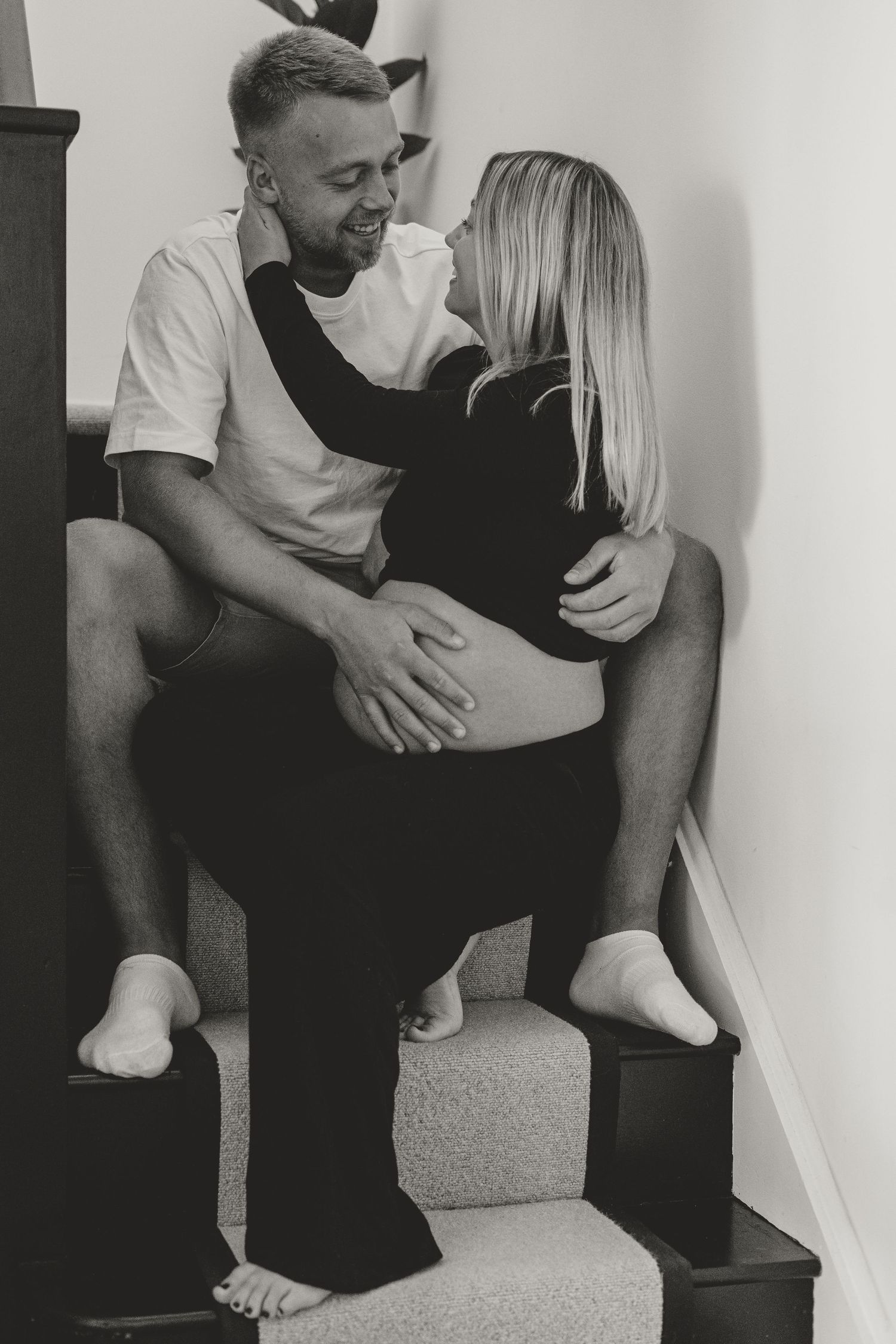 Intimate black and white photos showing a couple sitting together.