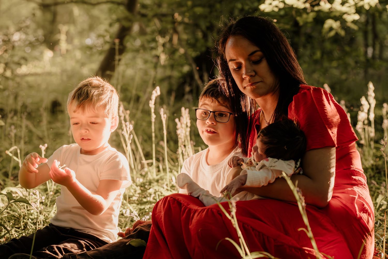 Family enjoying golden hour sunlight together in a natural outdoor setting.