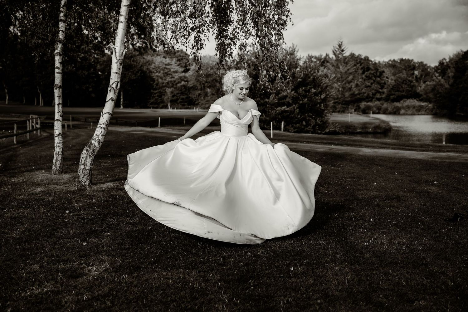 Black and white wedding photos showing a bride's dress flowing across a natural outdoor setting.