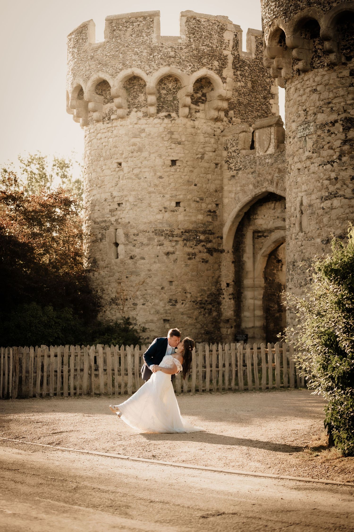 Romantic wedding portraits captured against ancient stone castle walls.
