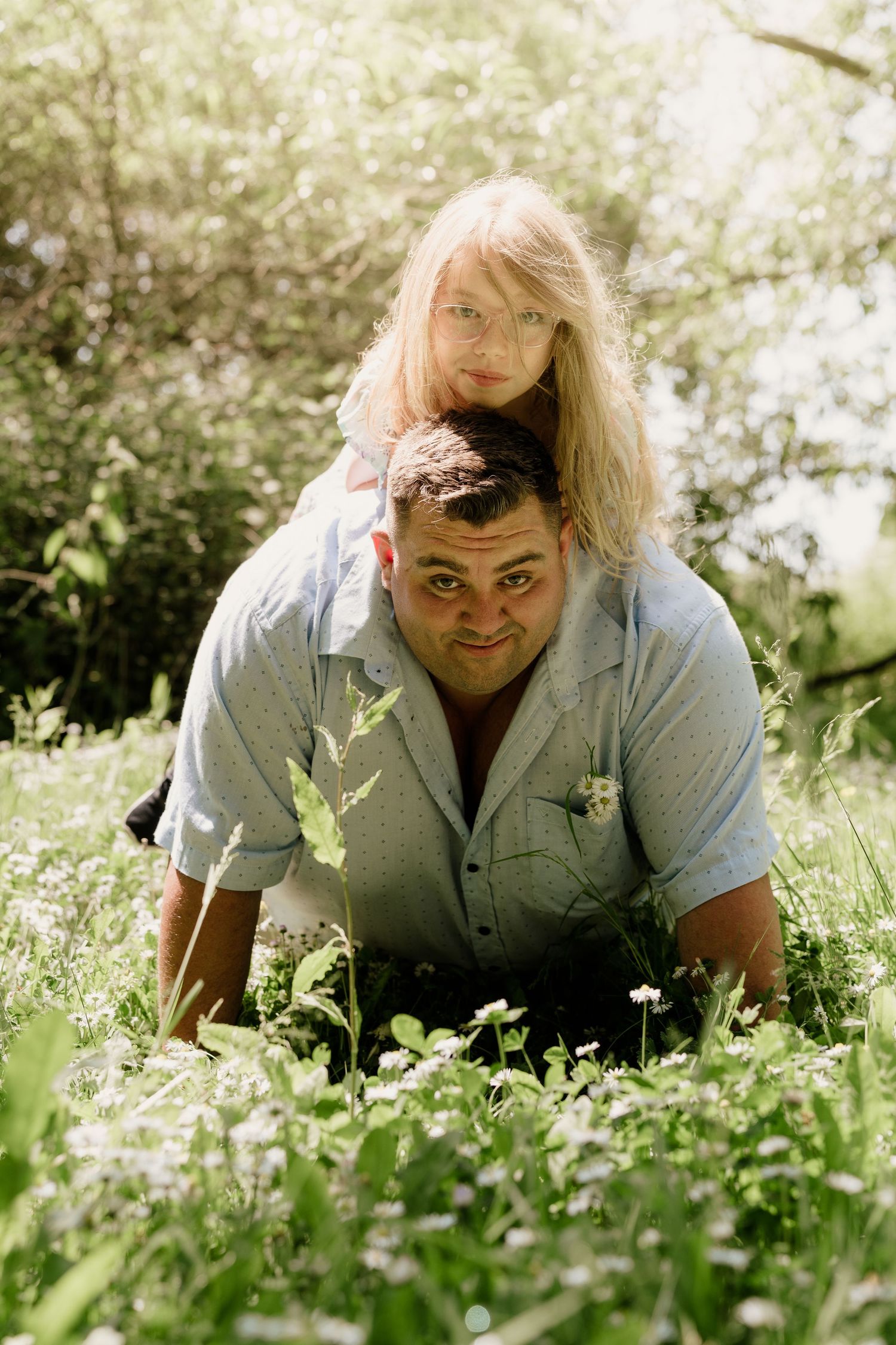 Person resting in a field of delicate white wildflowers during spring.