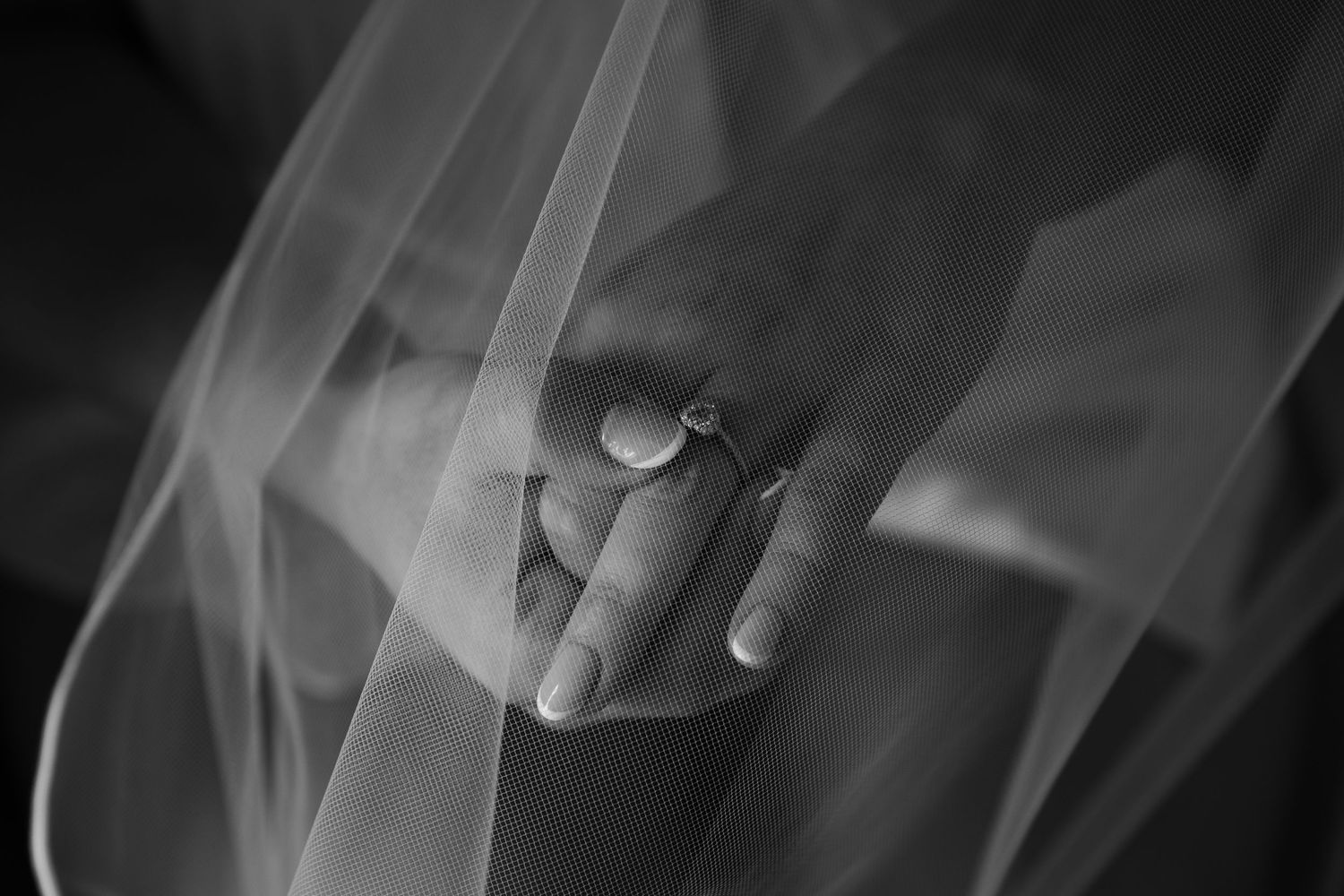 Black and white detail shots of wedding dress fabric and veil textures.