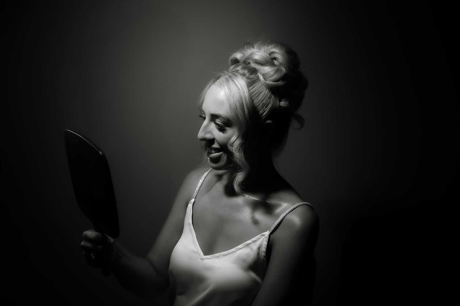 Dramatic black and white portrait with moody lighting and deep shadows.