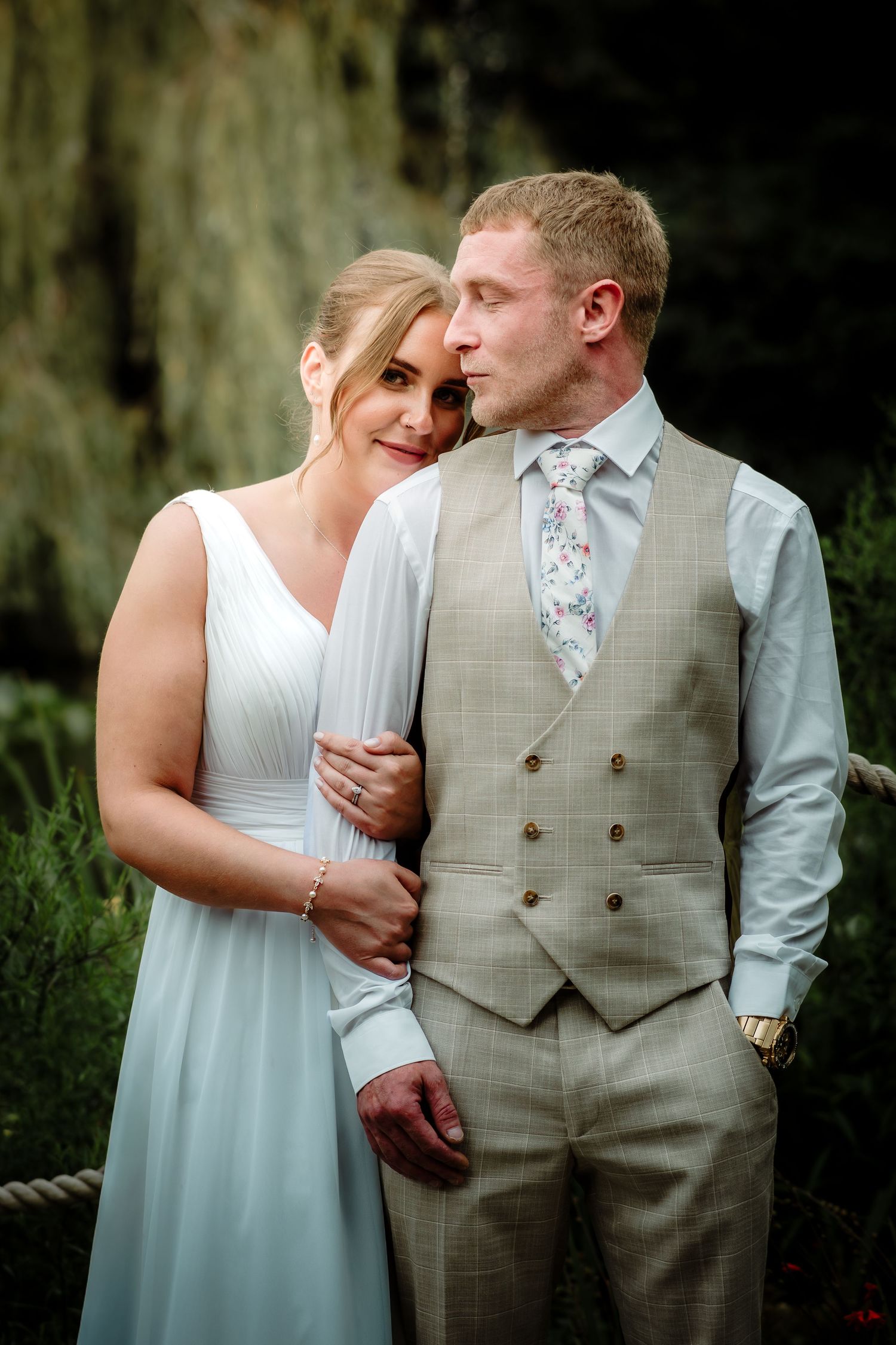A romantic wedding couple shares intimate moments in a series of outdoor portrait shots.