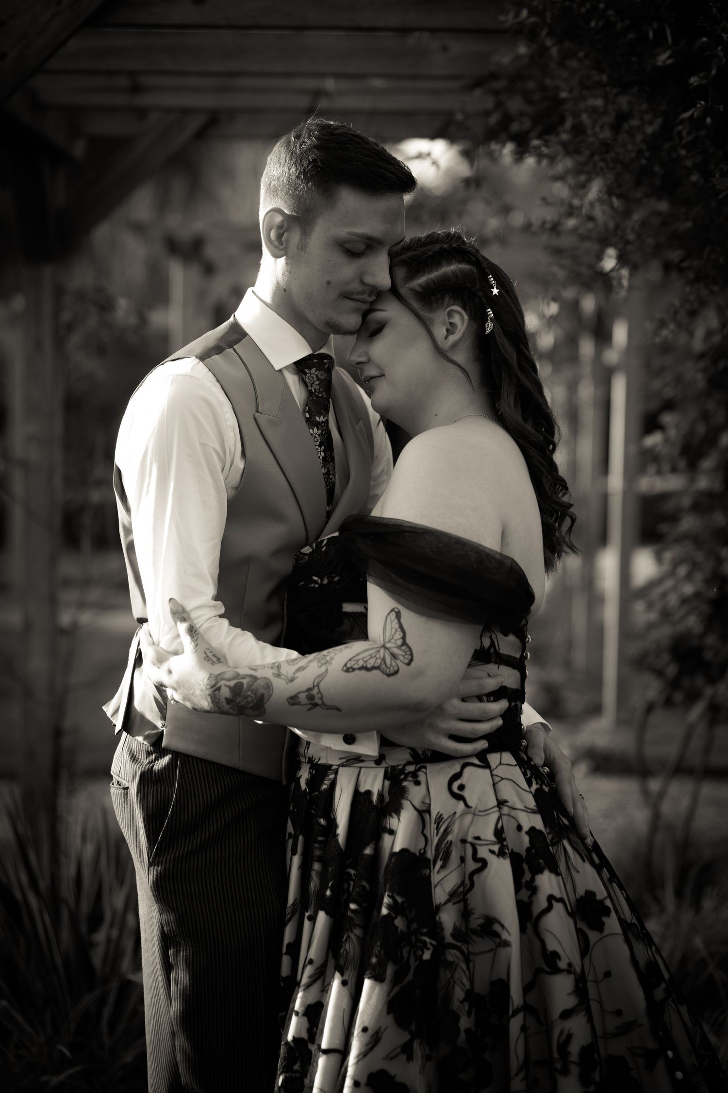 Romantic black and white portrait session in a garden setting.