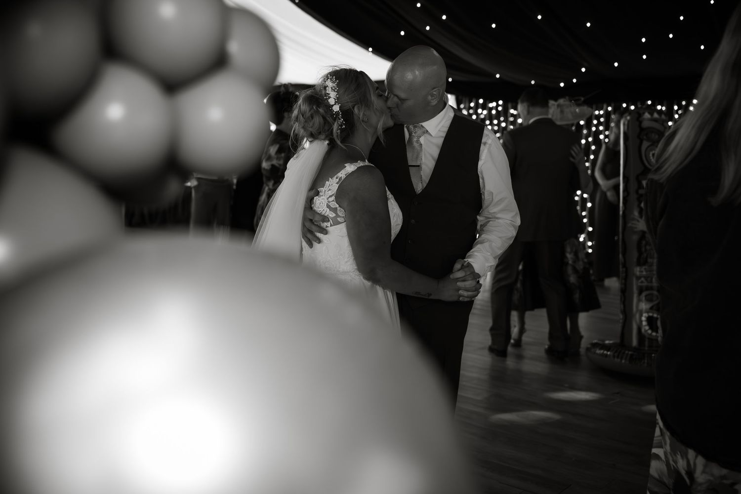 Dreamy black and white dance floor scene with bokeh lights.
