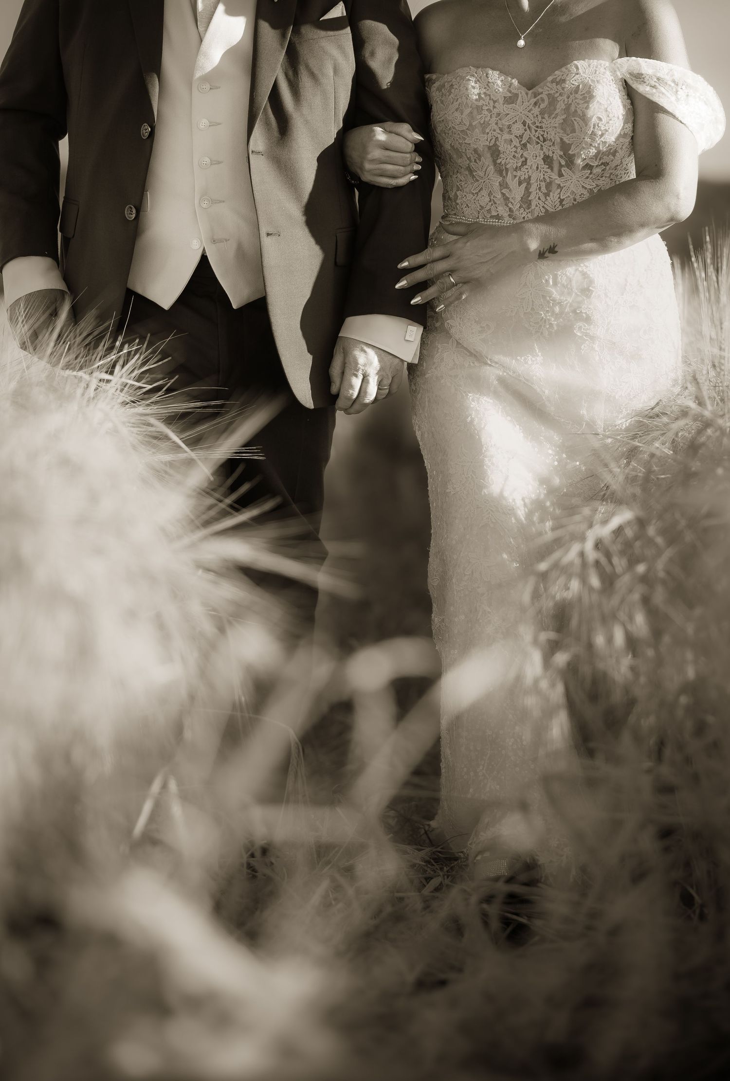 Black and white portrait of wedding attire details with dreamy bokeh effects.