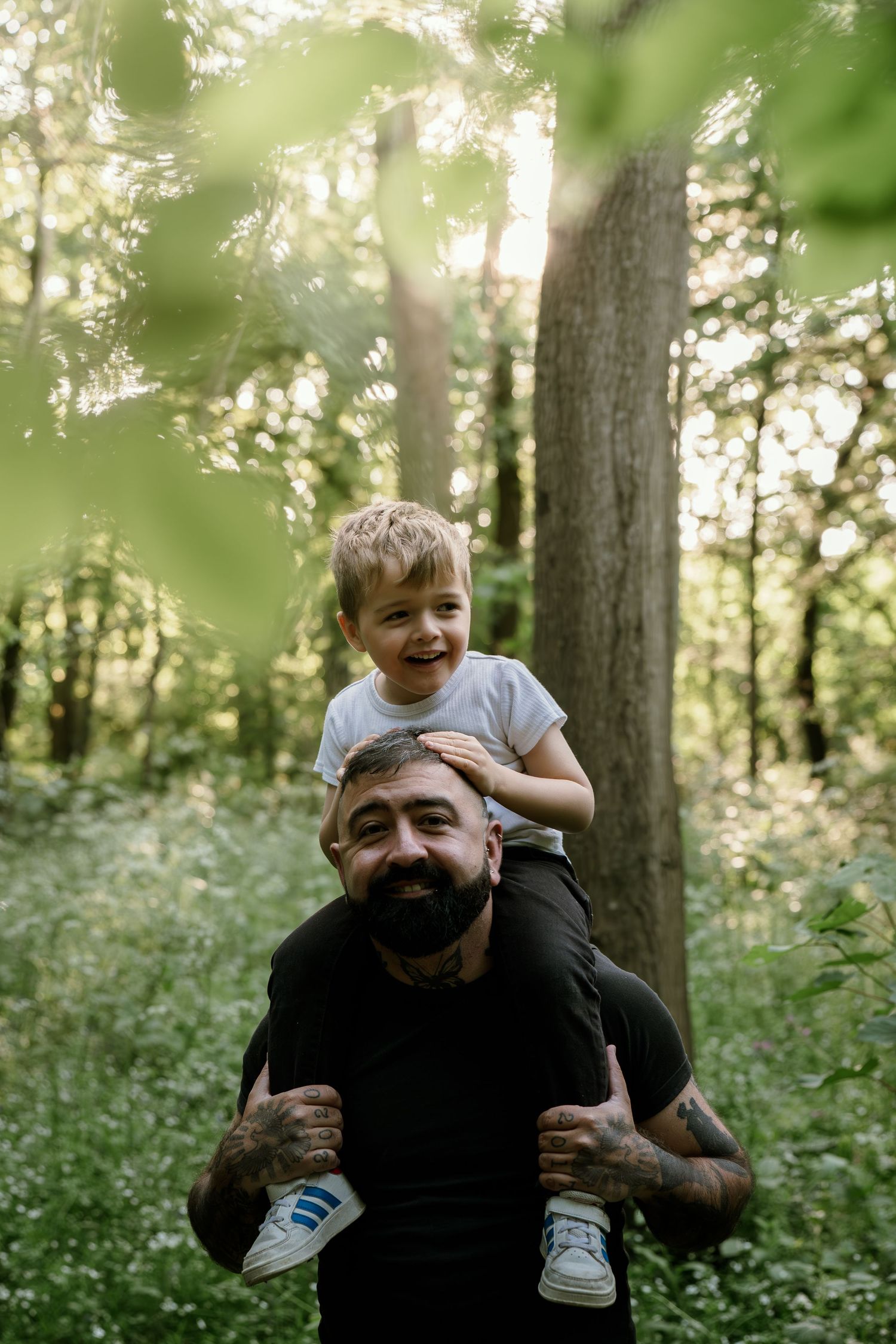 Joyful outdoor moments captured in a wooded setting with piggyback rides.