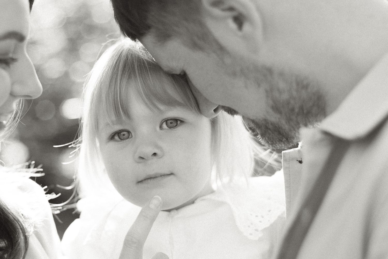 Intimate black and white portraits show tender family connections.