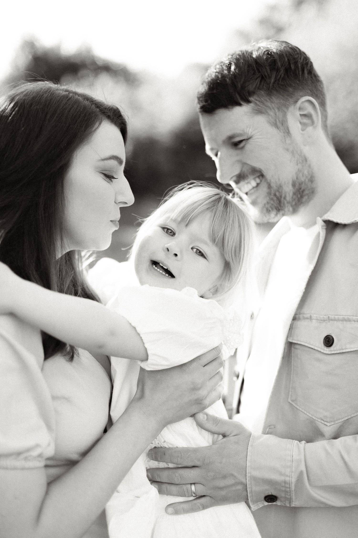 Intimate black and white photos capture loving family moments.