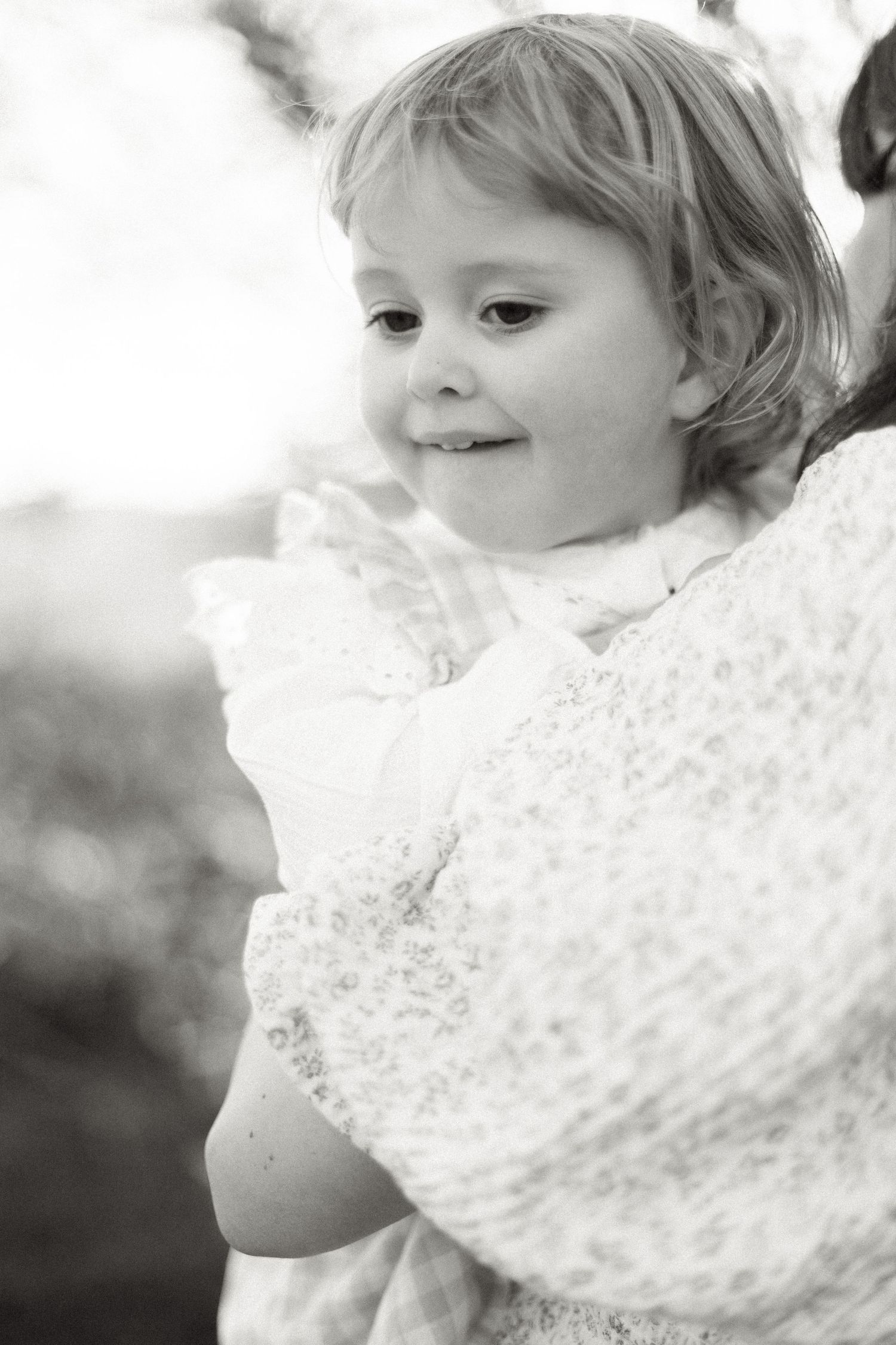 Close-up black and white portrait series showing gentle expressions and lace details.