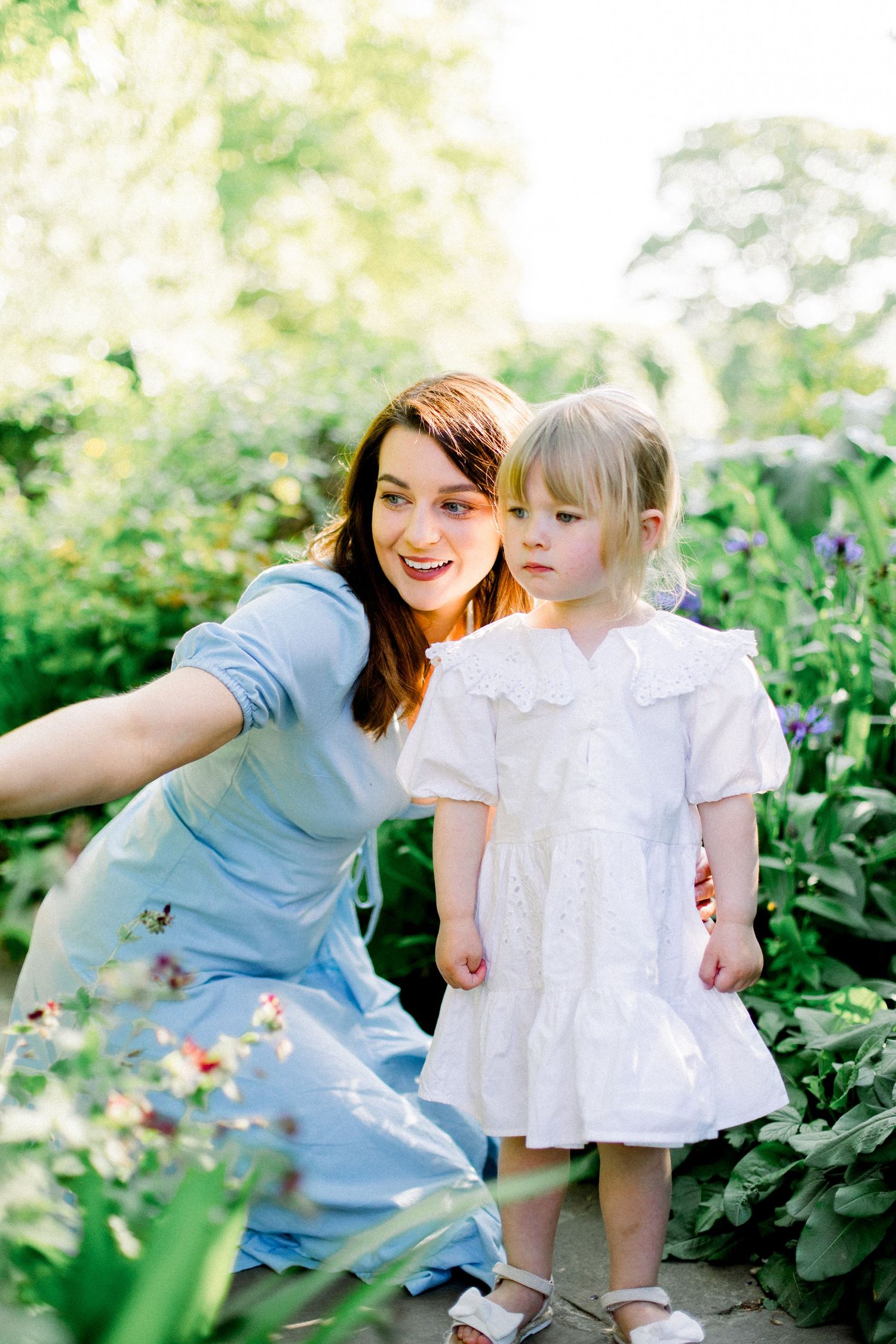 A sweet outdoor garden portrait showing loving interaction in natural sunlight.