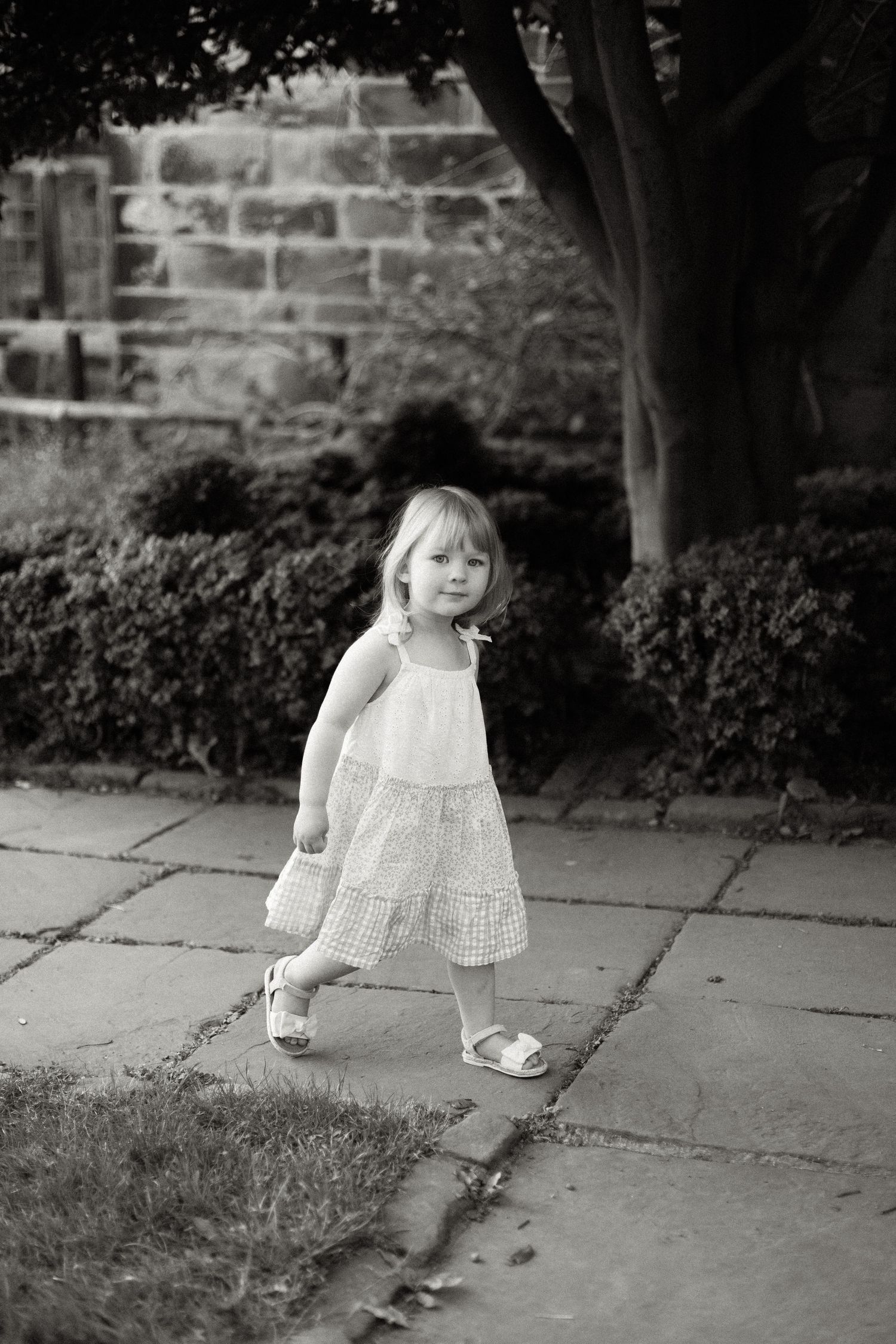 Series of black and white photos showing movement along stone pathway.