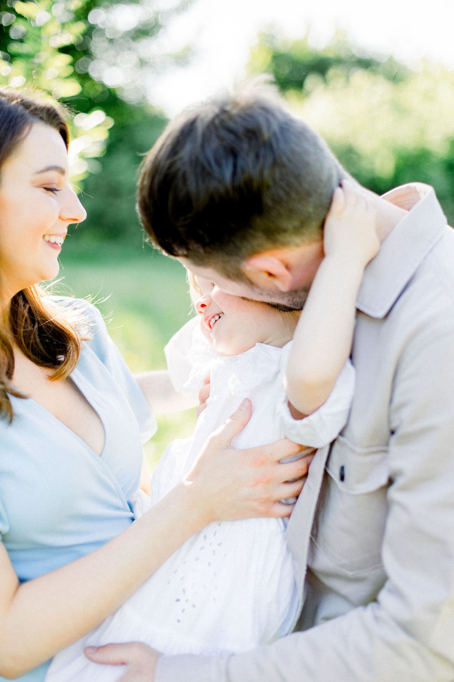 Candid family moments captured in a sun-drenched garden setting.