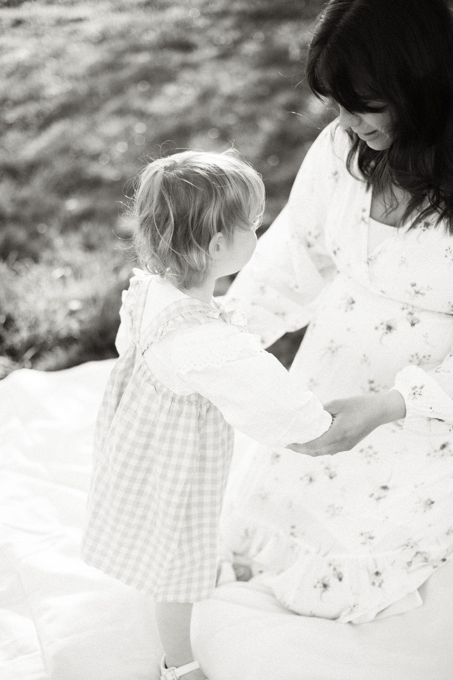 Delicate white lace and gingham fabrics captured in soft natural lighting.