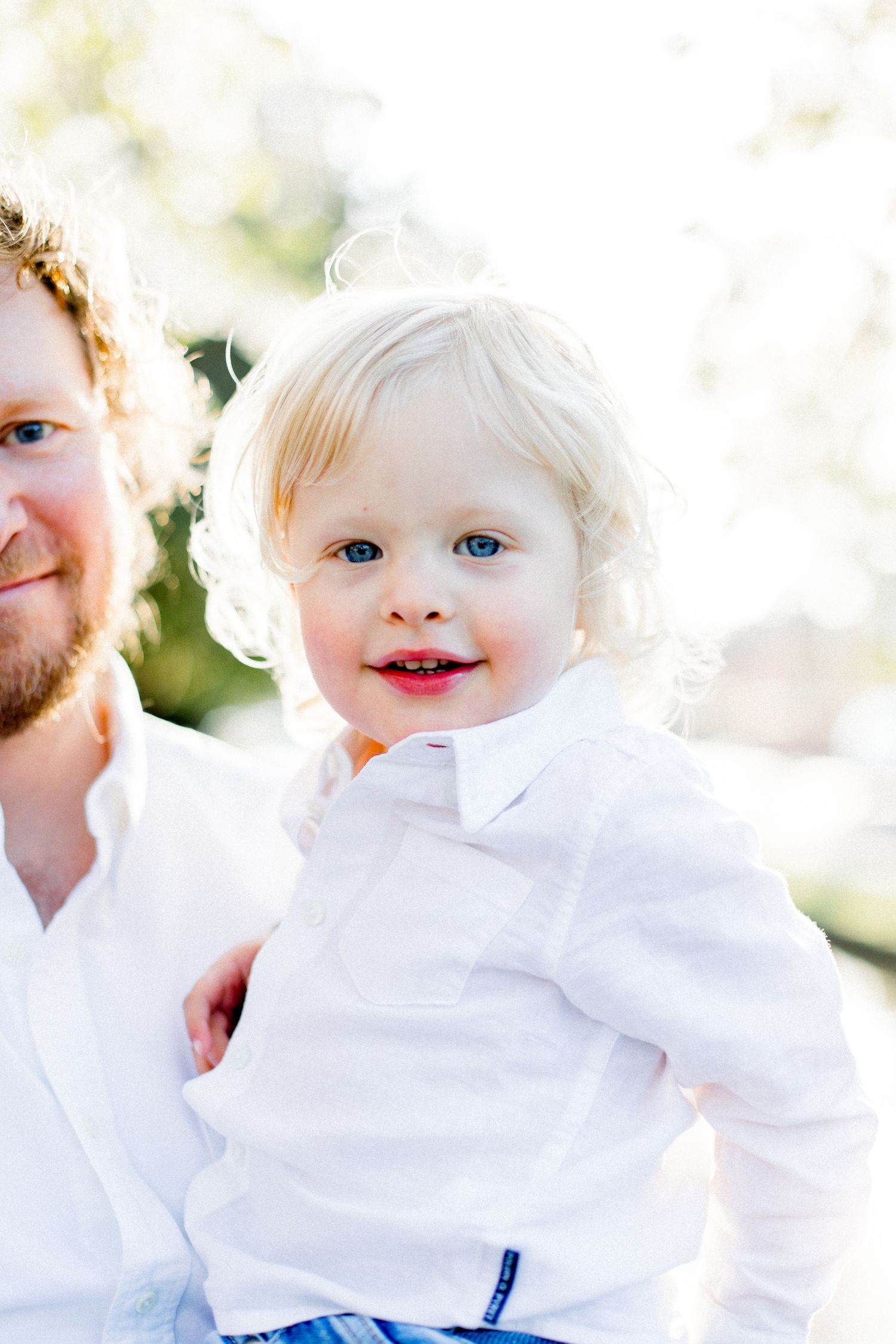Bright sunlit close-up portraits showing joyful expressions in white clothing.