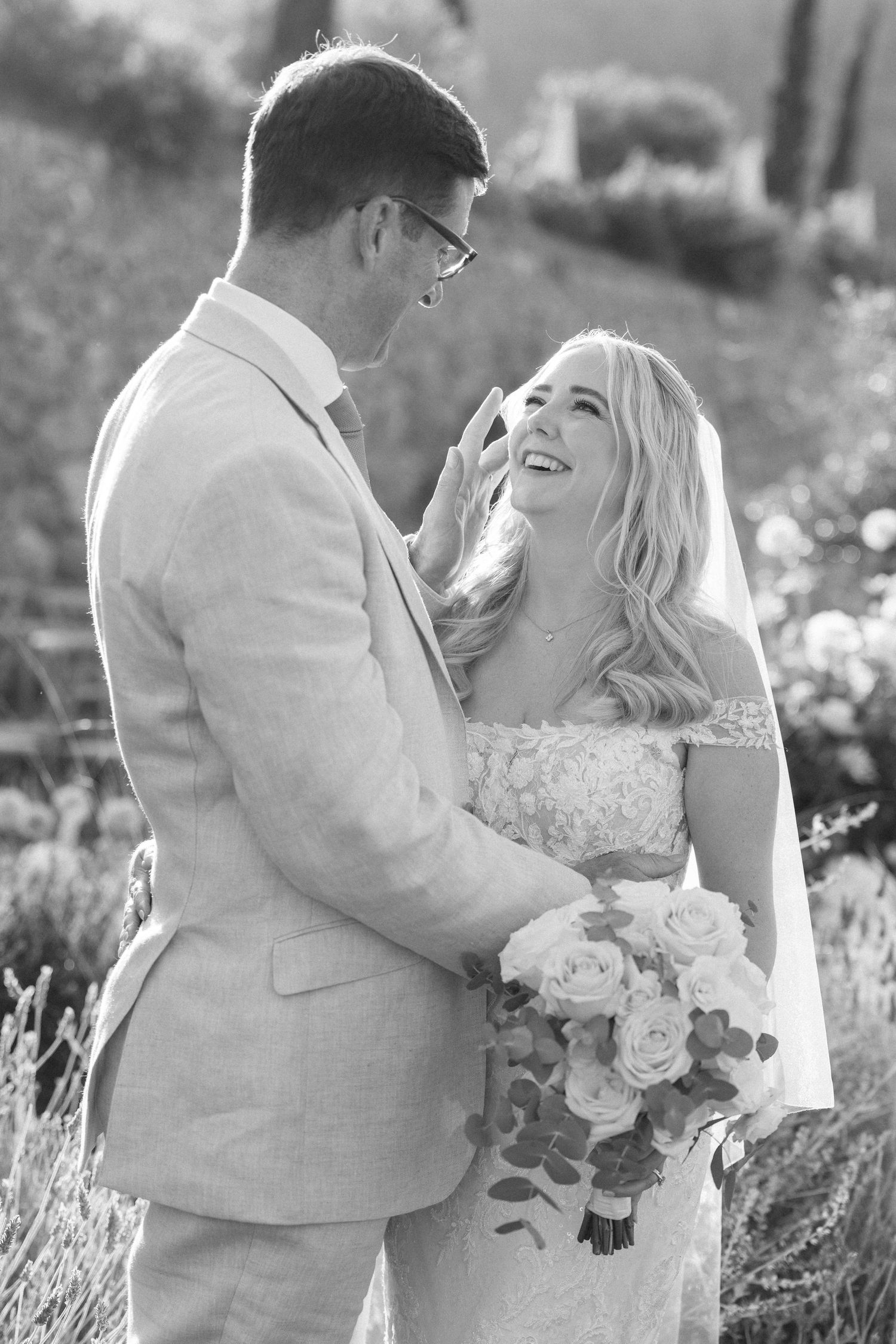 Black and white candid wedding portraits in a lavender field.