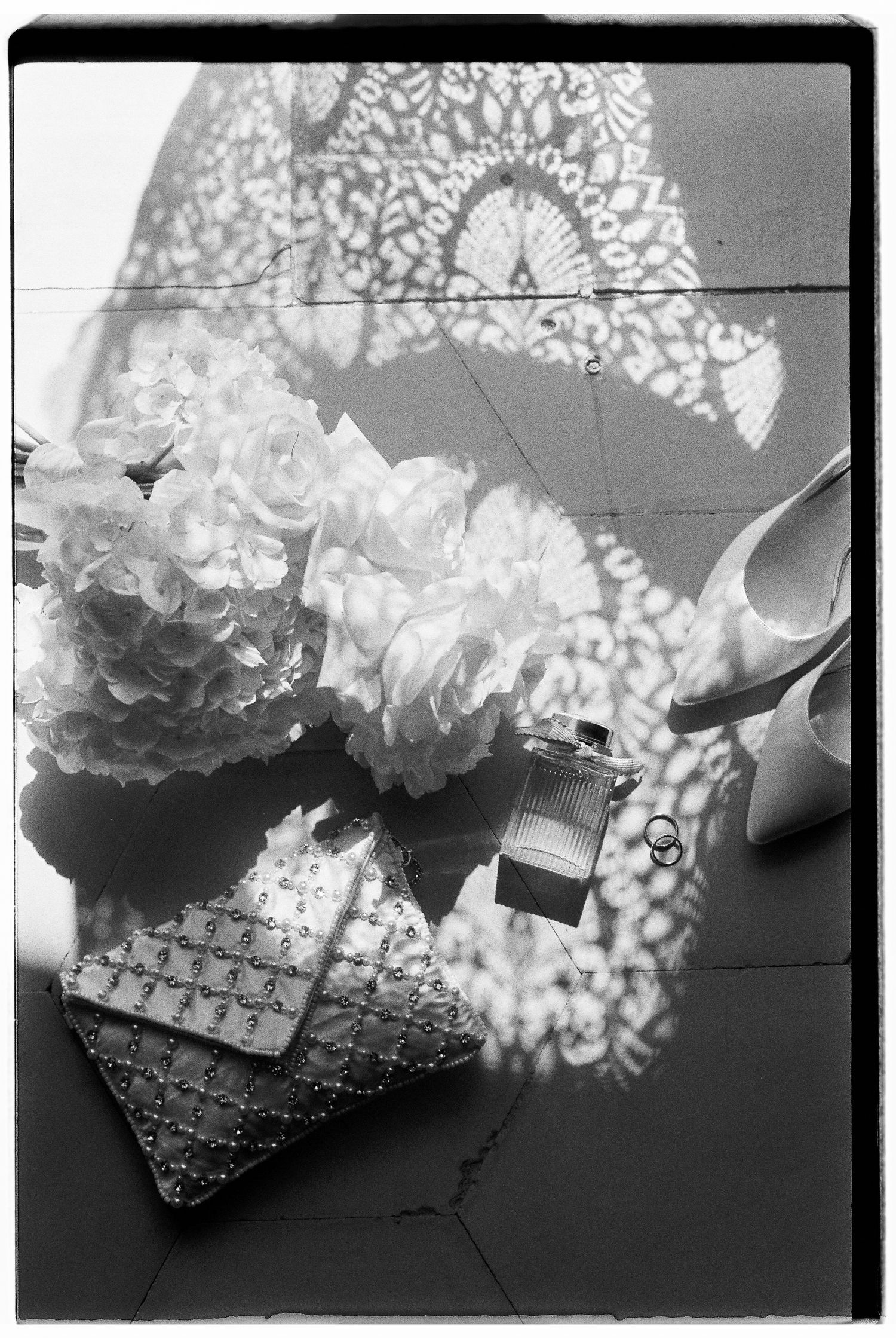 Black and white detail shot of lace patterns and floral arrangements.