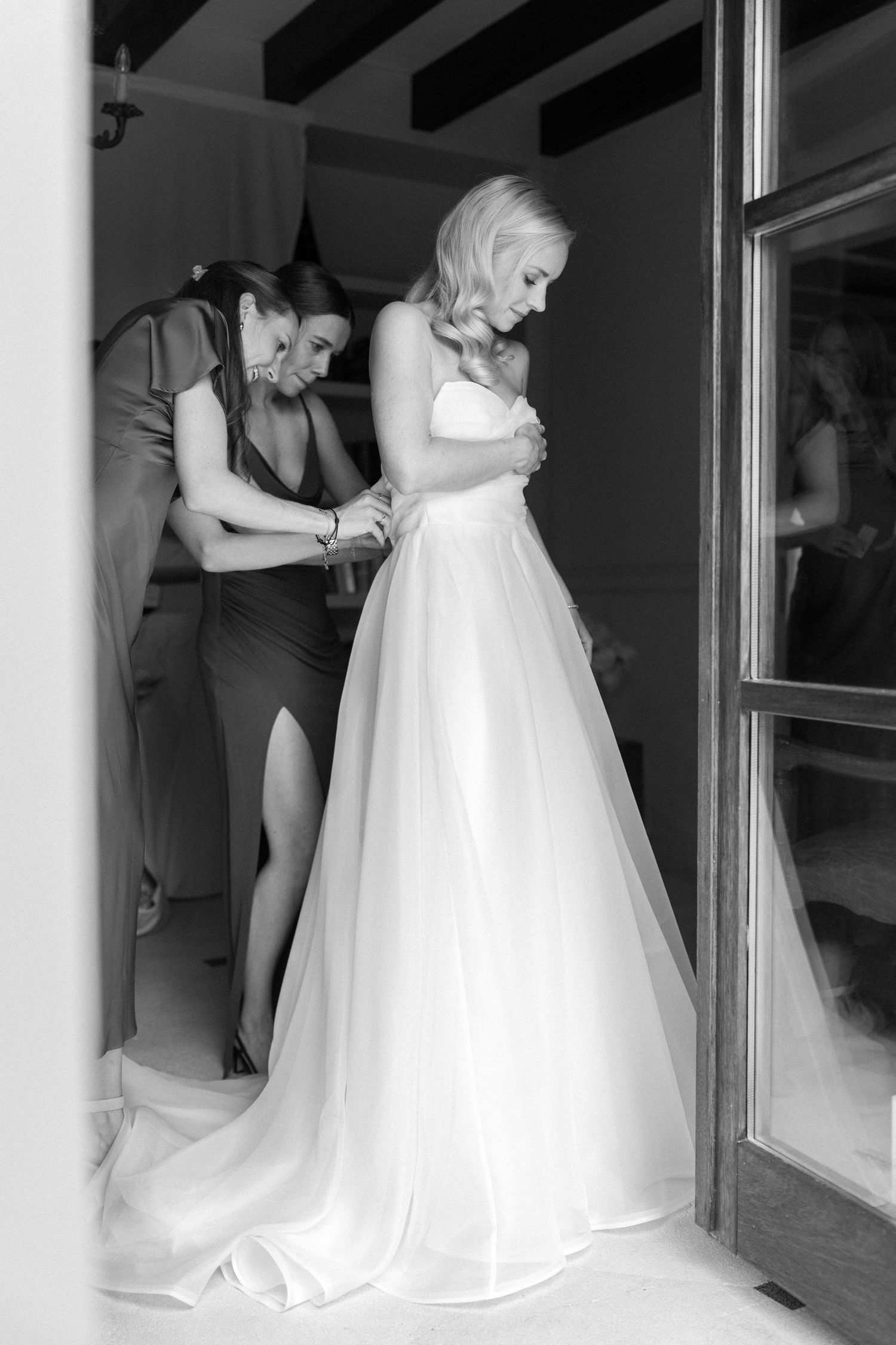 Wedding dress preparations captured in a series of black and white getting ready moments.