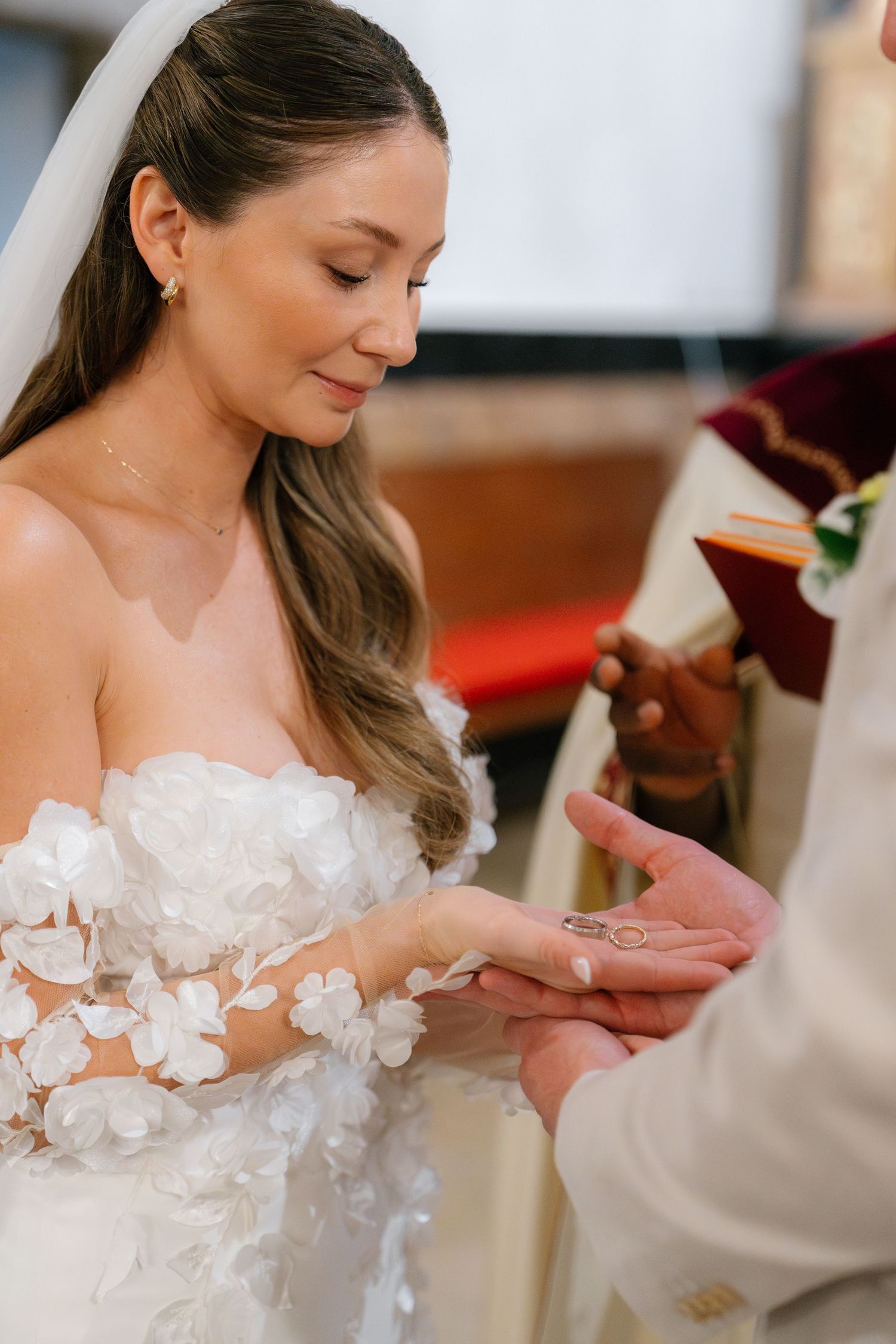 Close-up details of delicate white floral appliques on wedding attire.