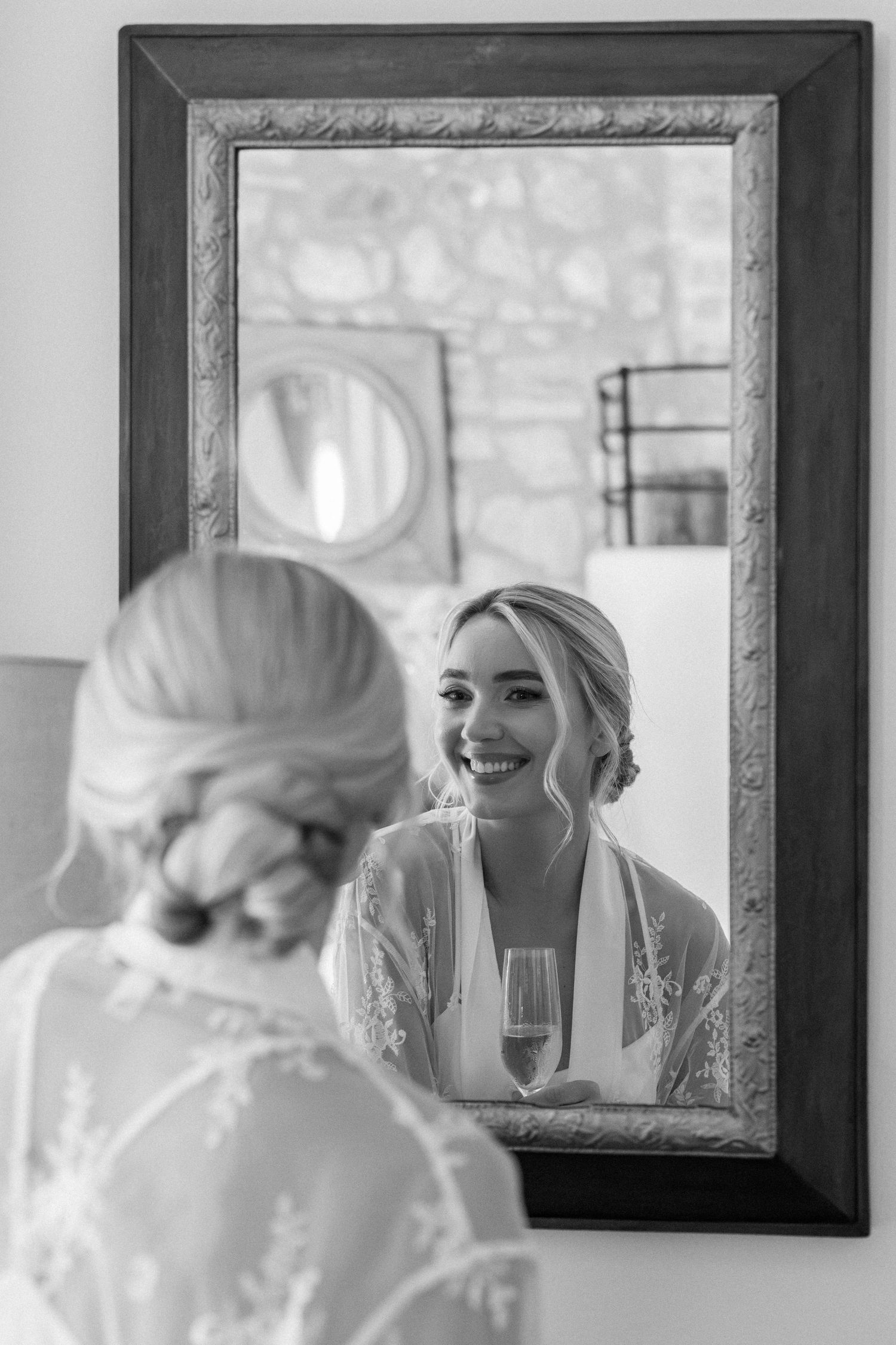 Getting ready scene with vintage mirrors and lace details in black and white.