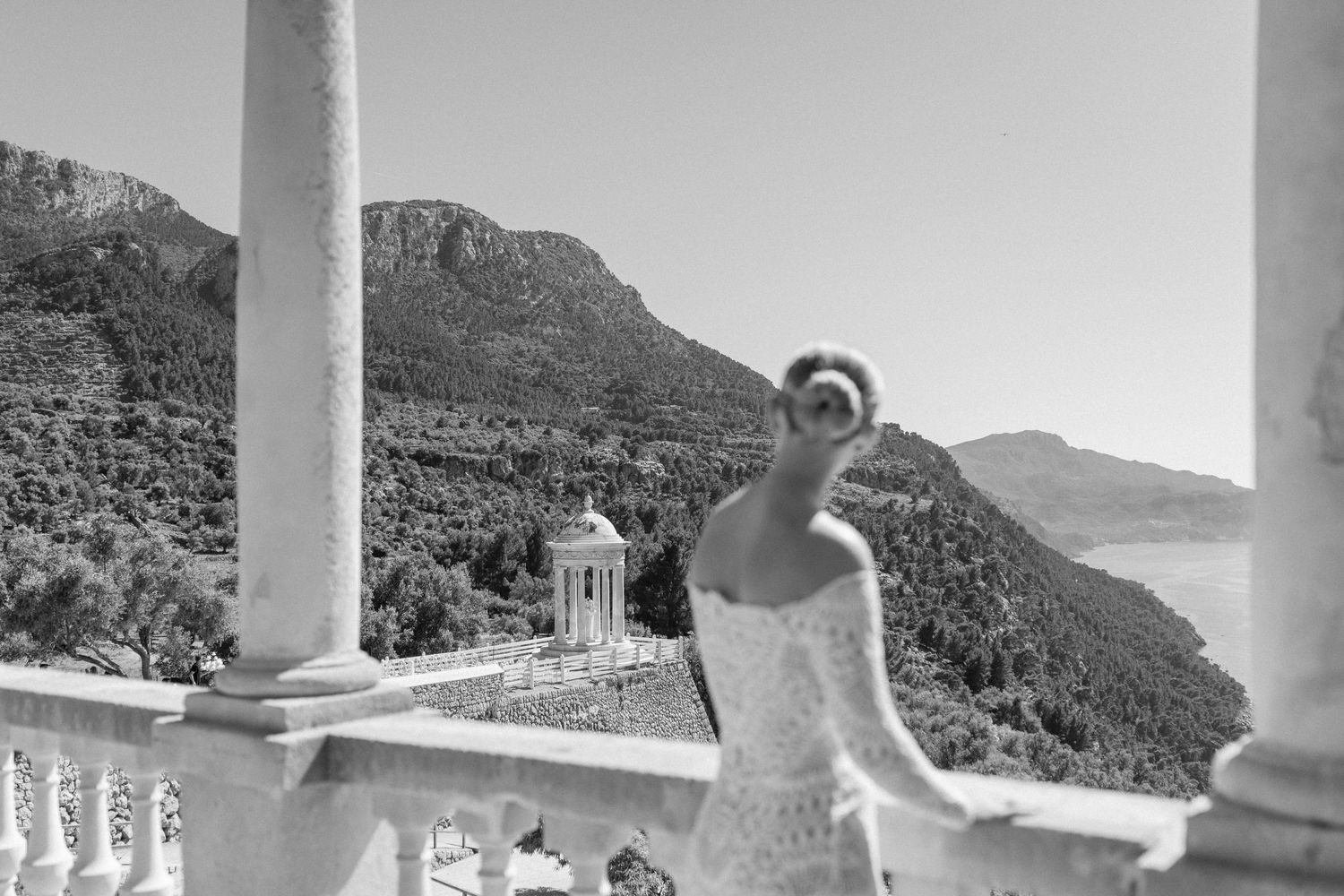 Scenic mountain views from an elegant balcony with white columns.