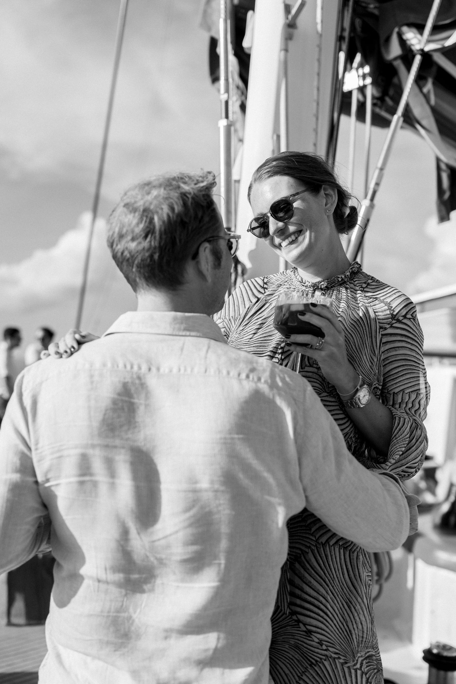 Guests sharing intimate conversations during a maritime celebration.