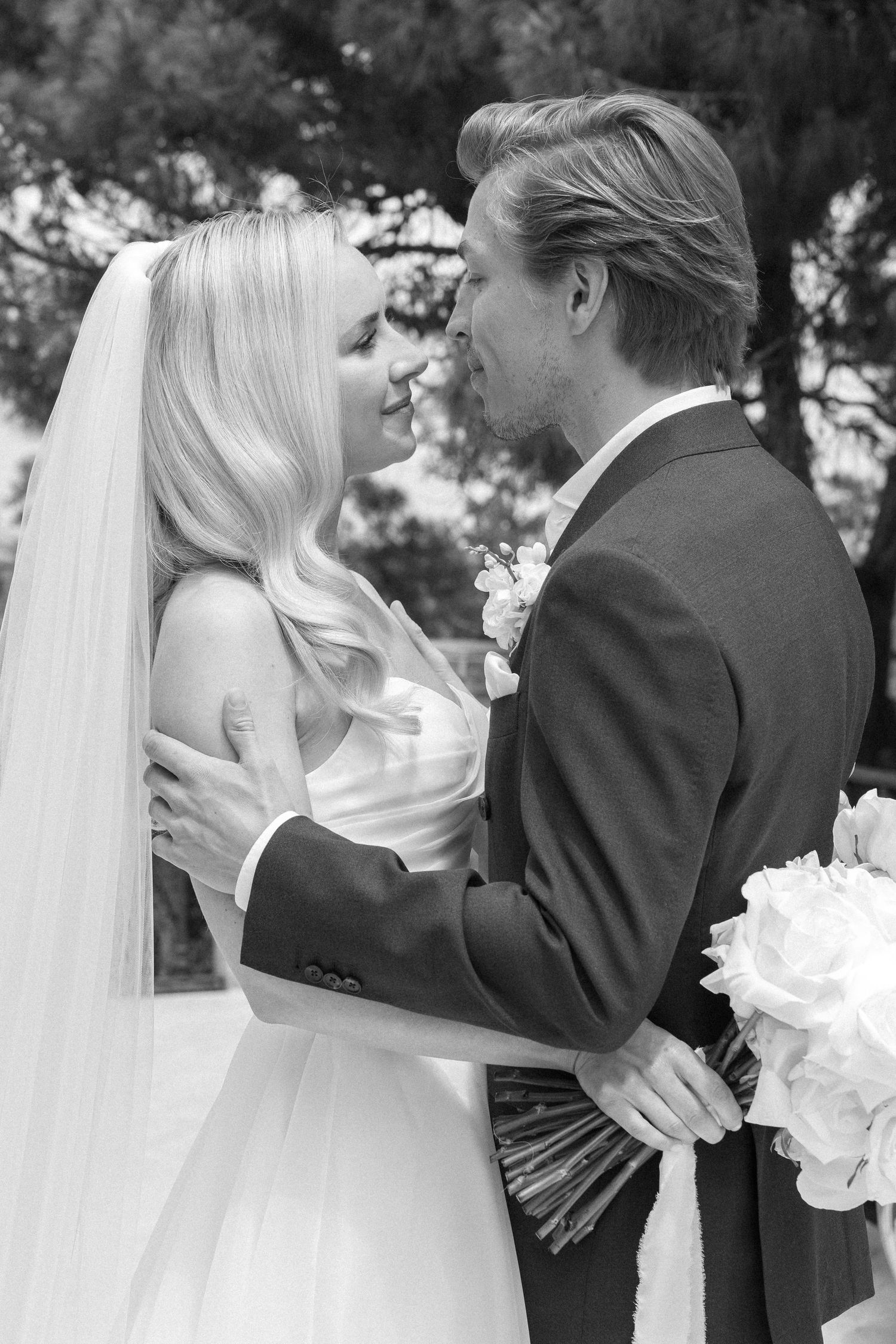 Black and white wedding photos showing intimate moments between bride and groom.