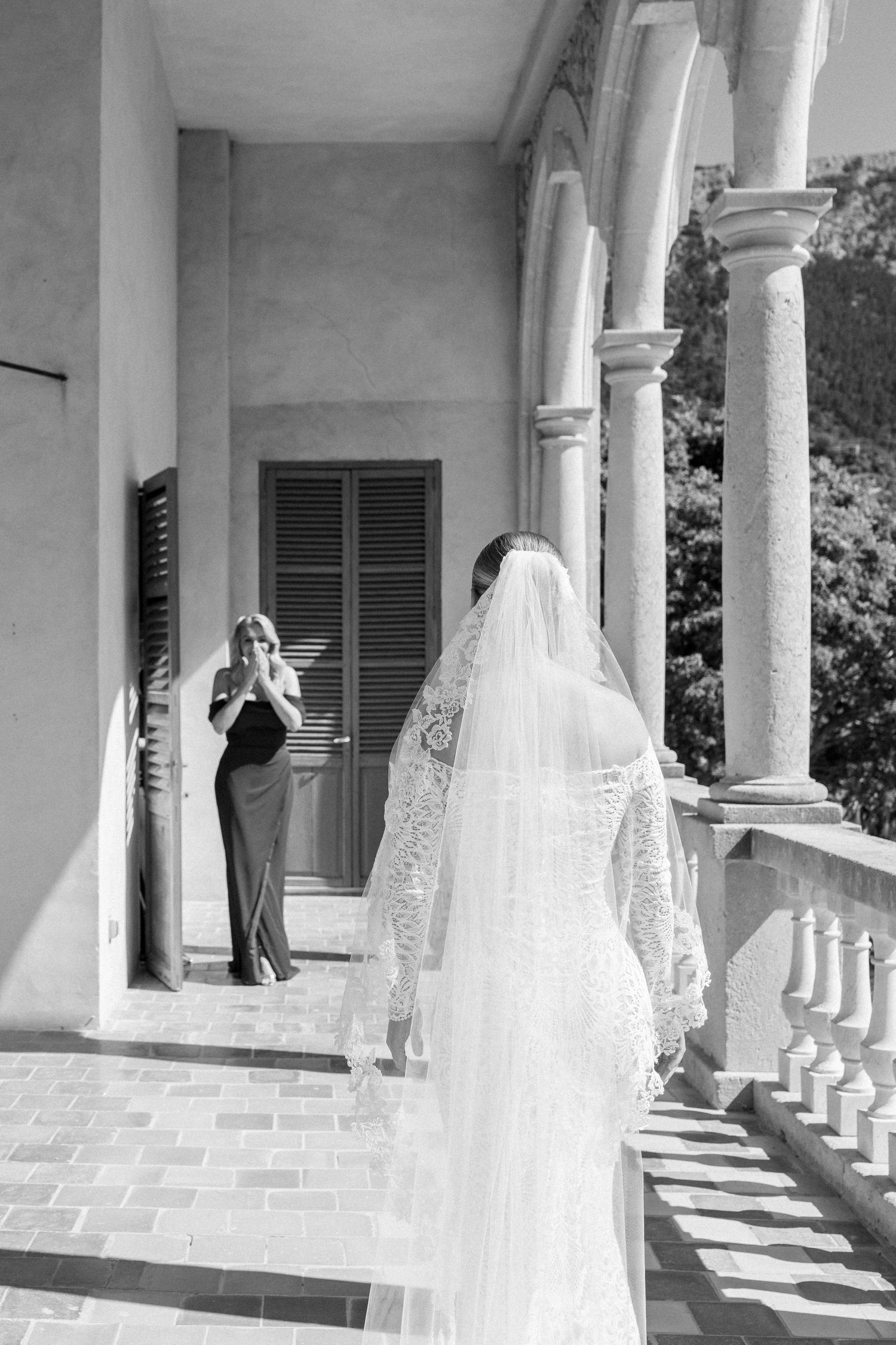 Wedding photography sequence along a Mediterranean villa's columned porch with mountain views.