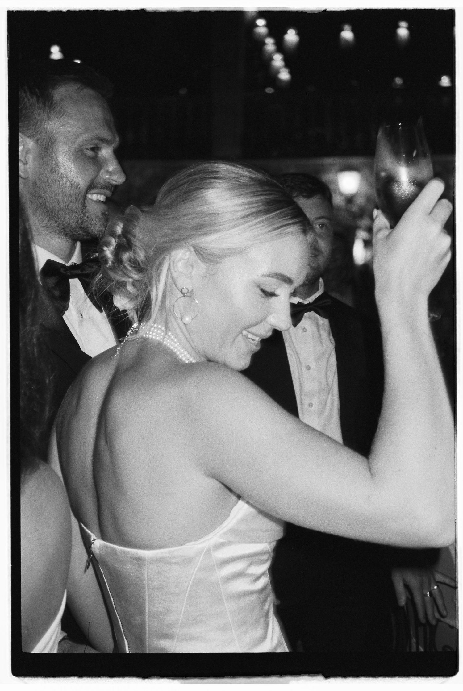 Dancing and celebration at an evening wedding reception.