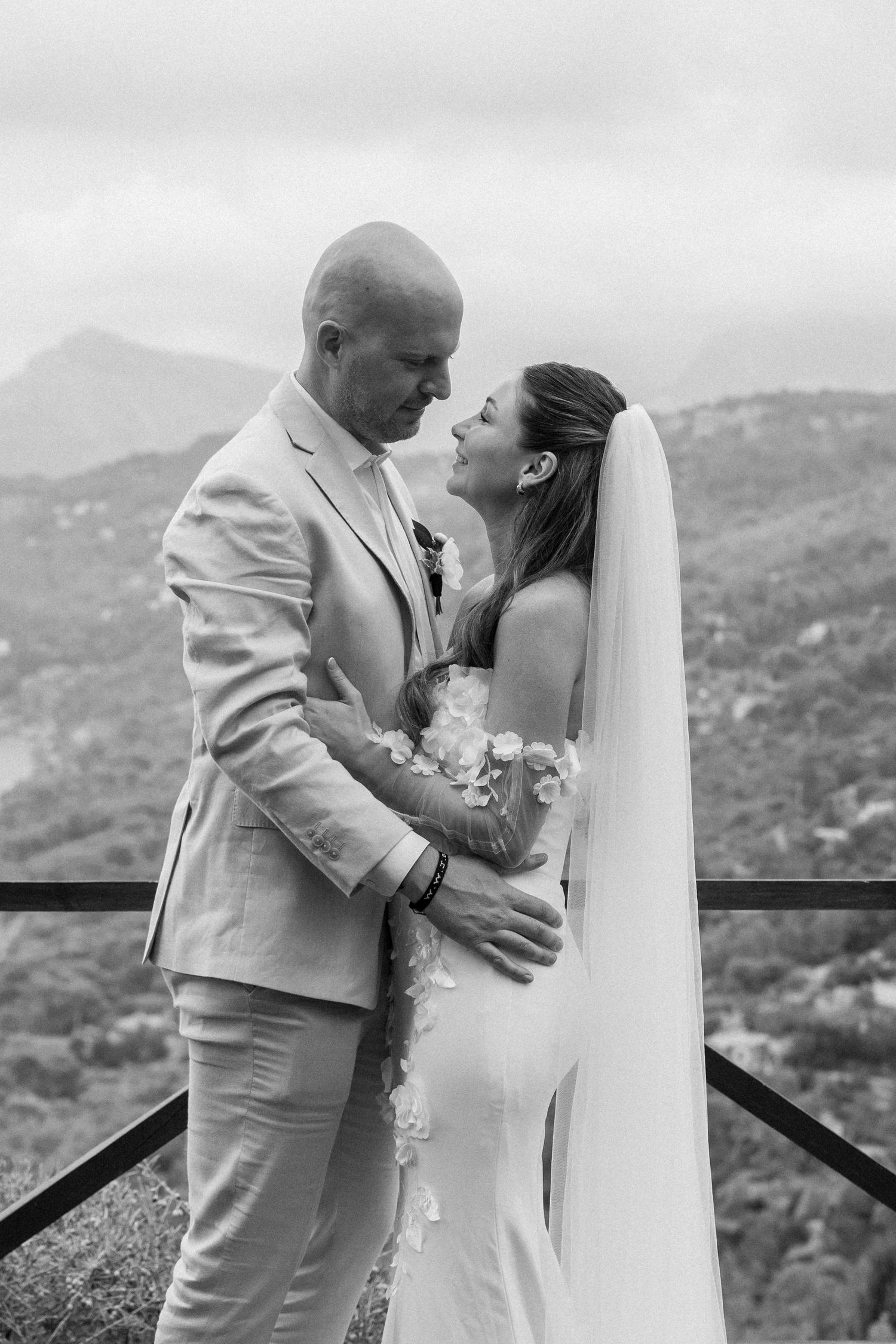 Intimate black and white wedding portraits captured against a mountainous backdrop.