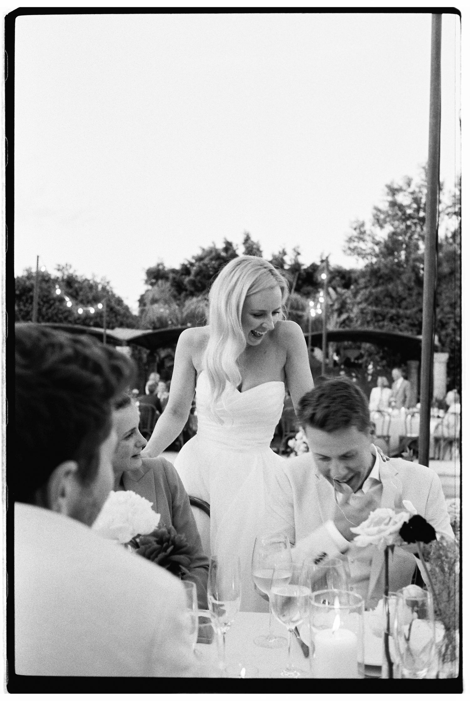 Wedding reception scene with guests seated at tables during dinner celebrations.
