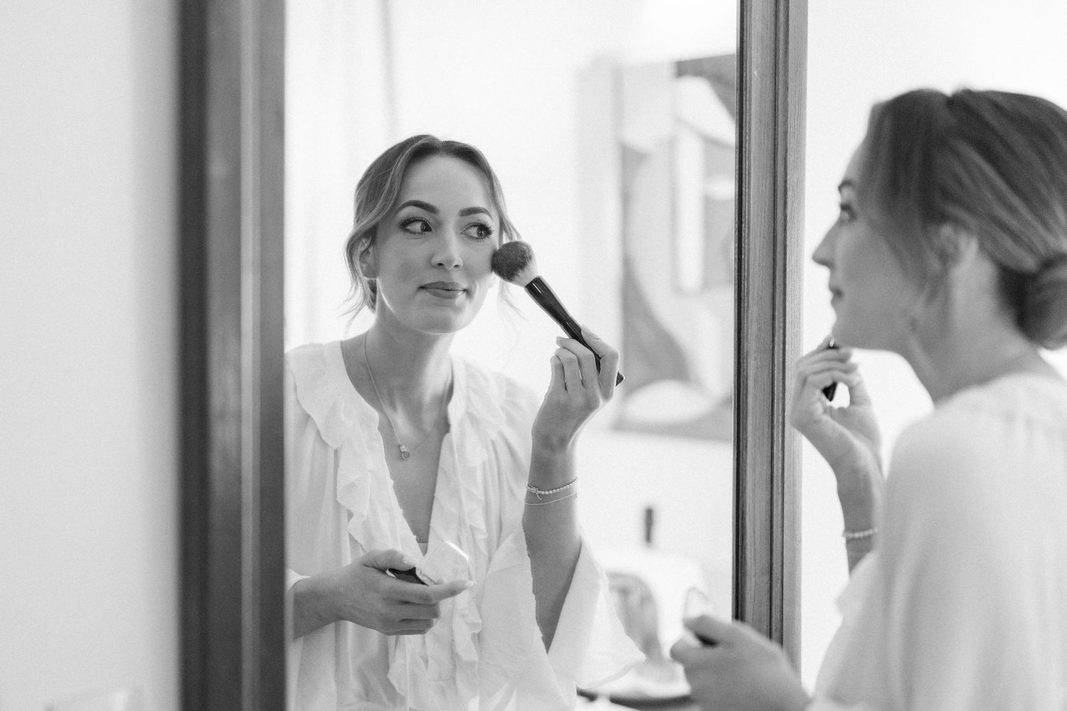 Black and white images of wedding preparation in bright interior space.
